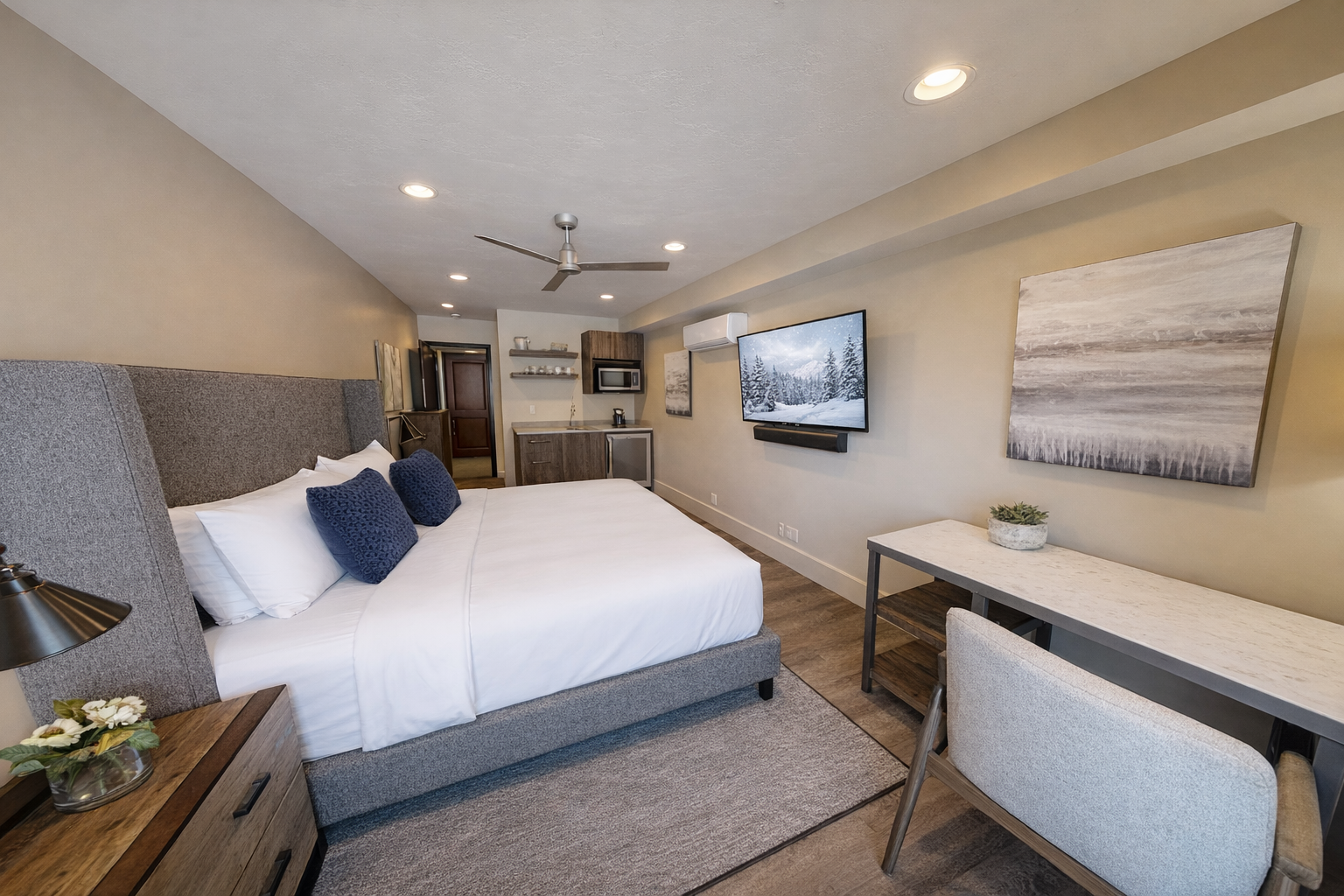 Unwind in your spacious suite featuring a plush king bed, modern kitchenette, and cozy workspace—your perfect home away from home.