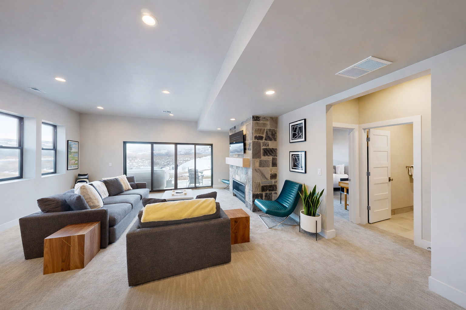 Sink into your plush sectional sofa and enjoy panoramic views through floor-to-ceiling windows in this stylish living space with modern fireplace.