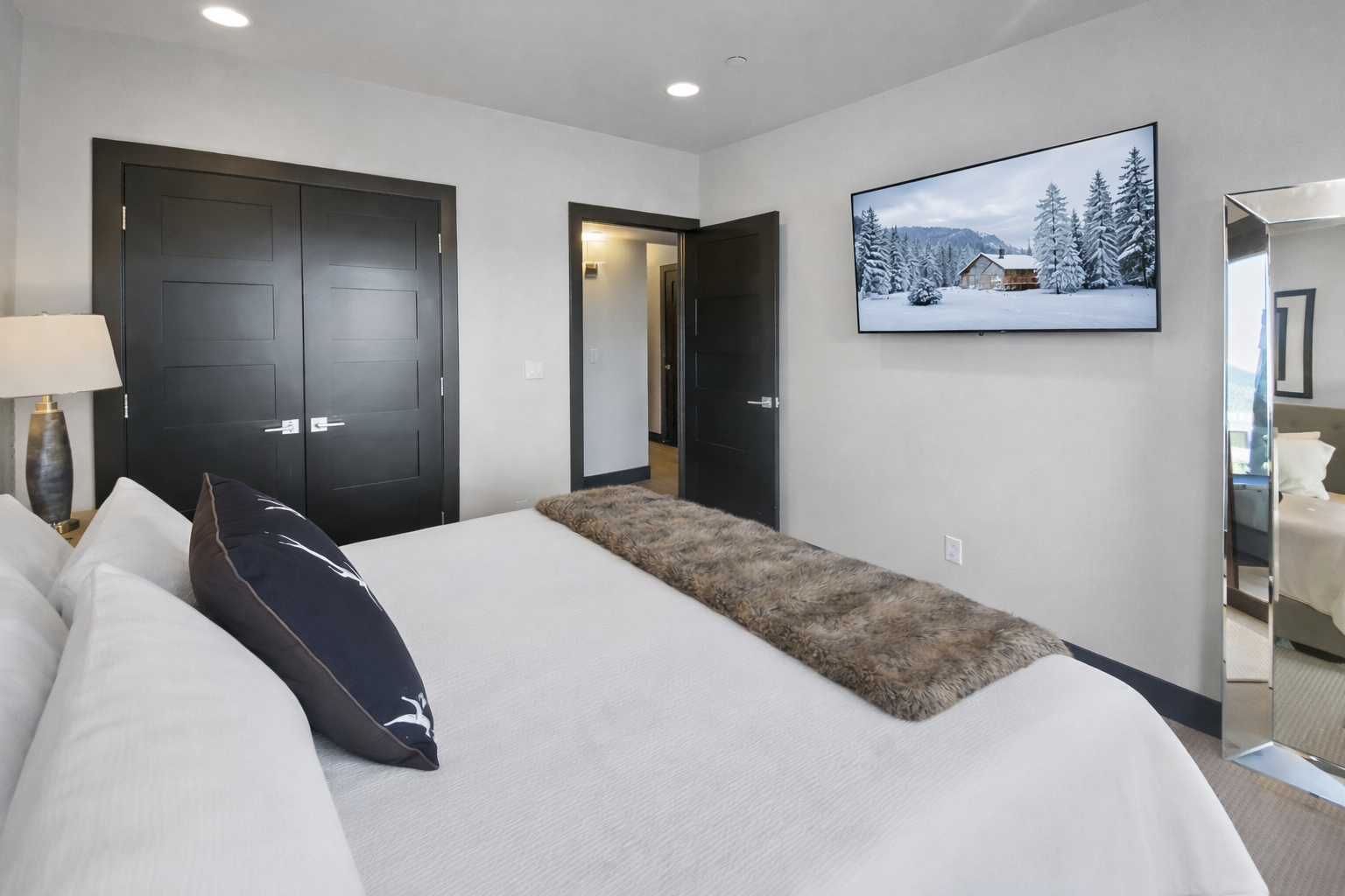 Sink into this plush king bed while watching your favorite shows on the wall-mounted TV in your serene bedroom retreat.