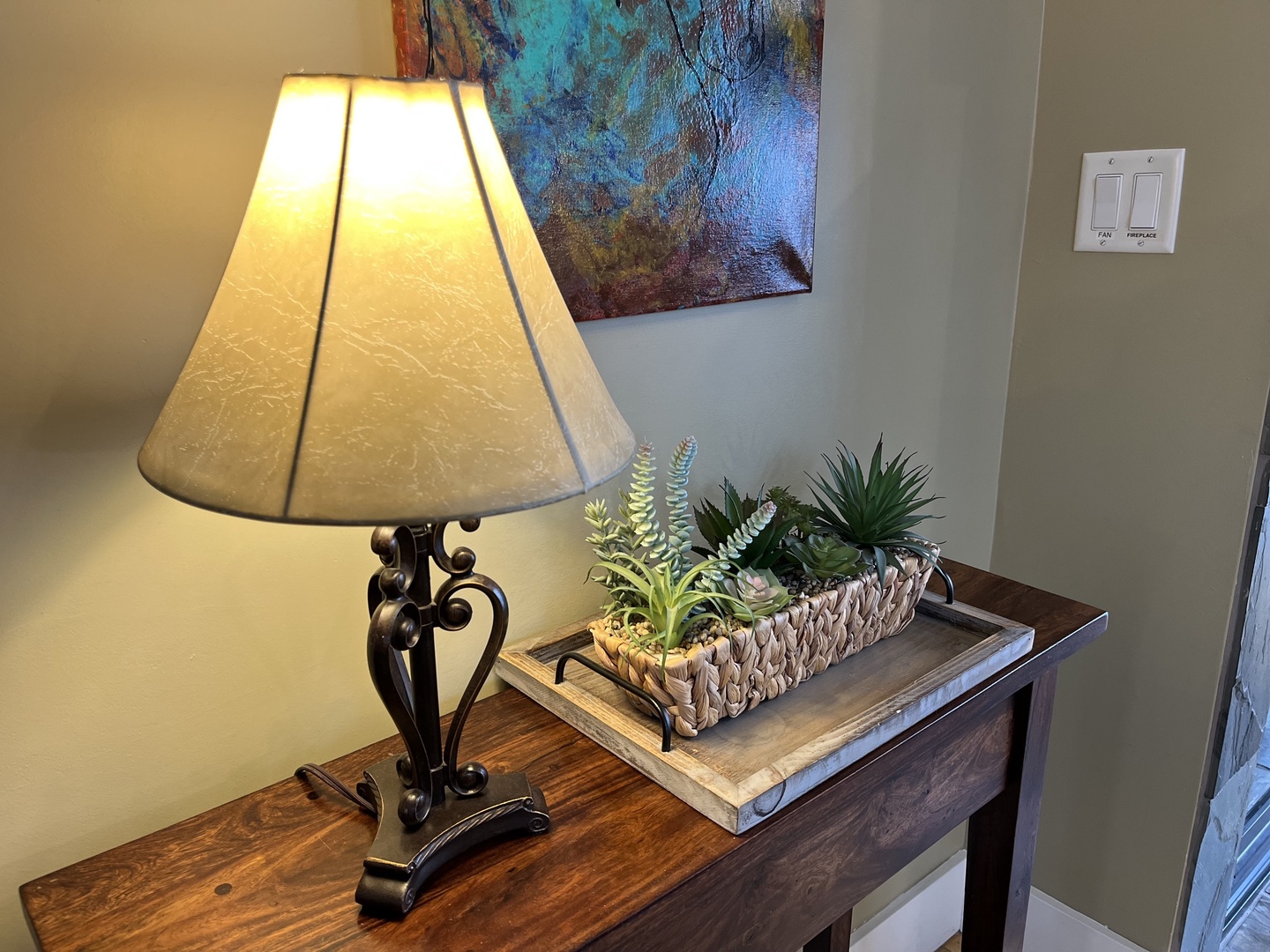 Relax in this cozy mountain retreat featuring a warm fireplace, rustic wooden accents, and plush seating. Enjoy modern amenities like a wall-mounted TV and large windows with bright, natural light.