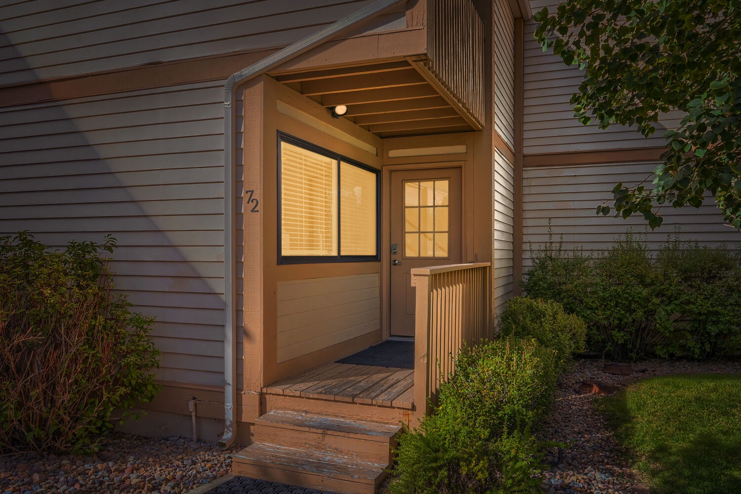The welcoming entrance to your home away from home, where soft evening light and a quiet garden setting mark the beginning of your retreat.