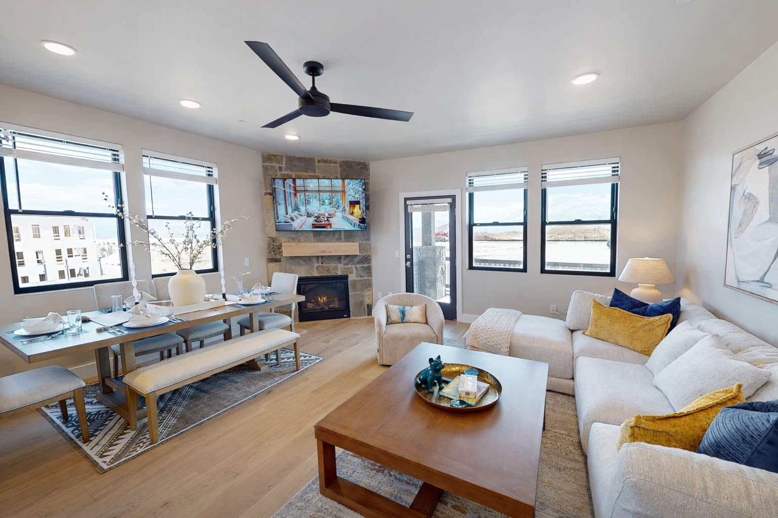 Relax in your bright open living space where modern comfort meets warmth, complete with cozy fireplace and stylish furnishings.