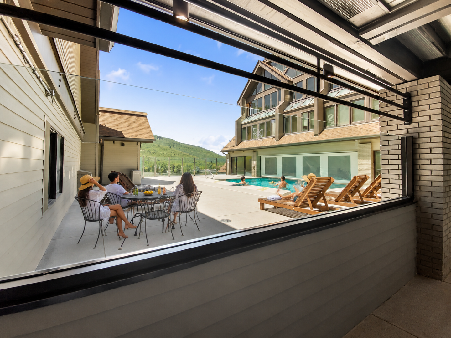 Your private patio opens to a sparkling pool and inviting sundeck, with mountain views framing every moment of your escape.