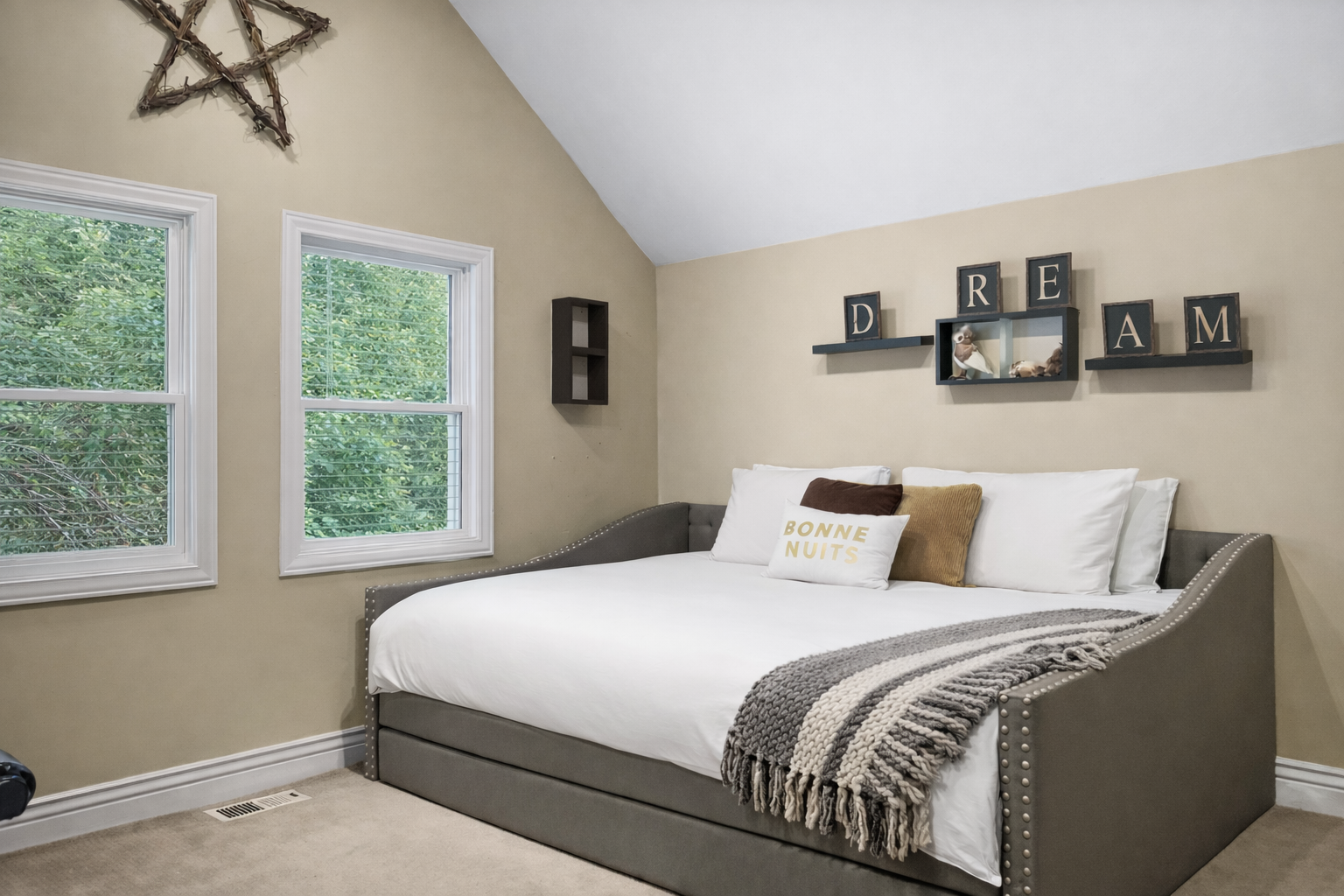 Unwind in your cozy daybed with inspiring wall art and garden views through bright windows—perfect for afternoon naps or reading.