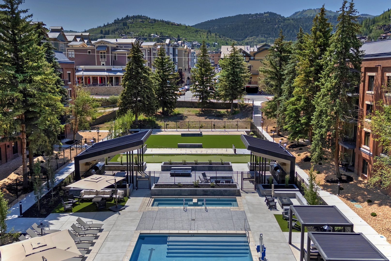Beautiful Swimming Pool with lots of Sunlight. Lounge Chairs and Cabanas to relax and enjoy the Summer Heat and Excellent Mountain Views