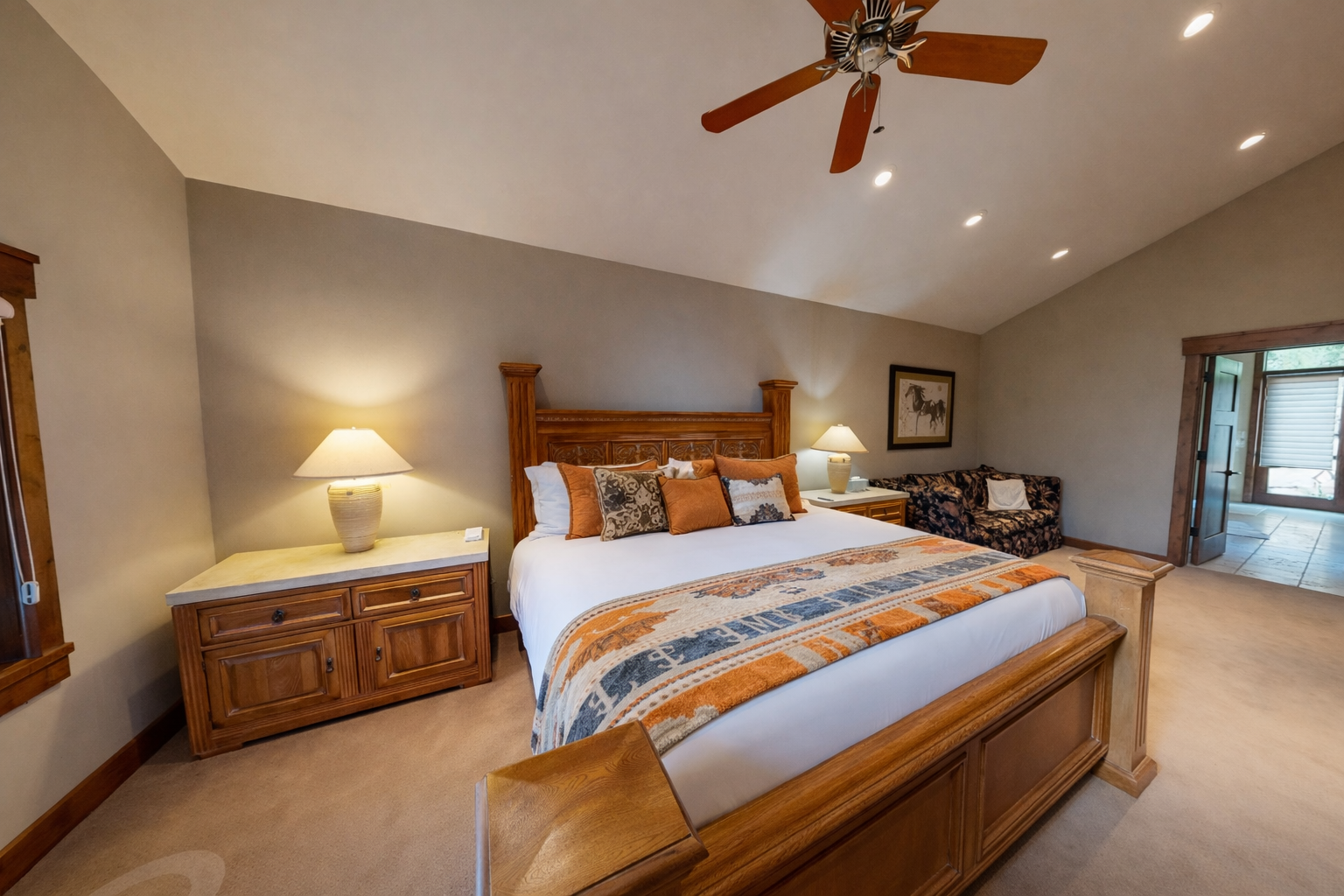 Unwind in your peaceful bedroom sanctuary with rich wood furnishings, cathedral ceilings, and soft lighting creating pure tranquility.