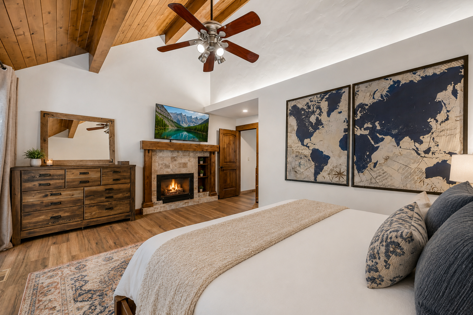 Unwind in your serene bedroom retreat featuring a cozy fireplace, vaulted wood ceilings, and luxurious bedding—perfect for restful nights after exploring nearby mountain adventures.