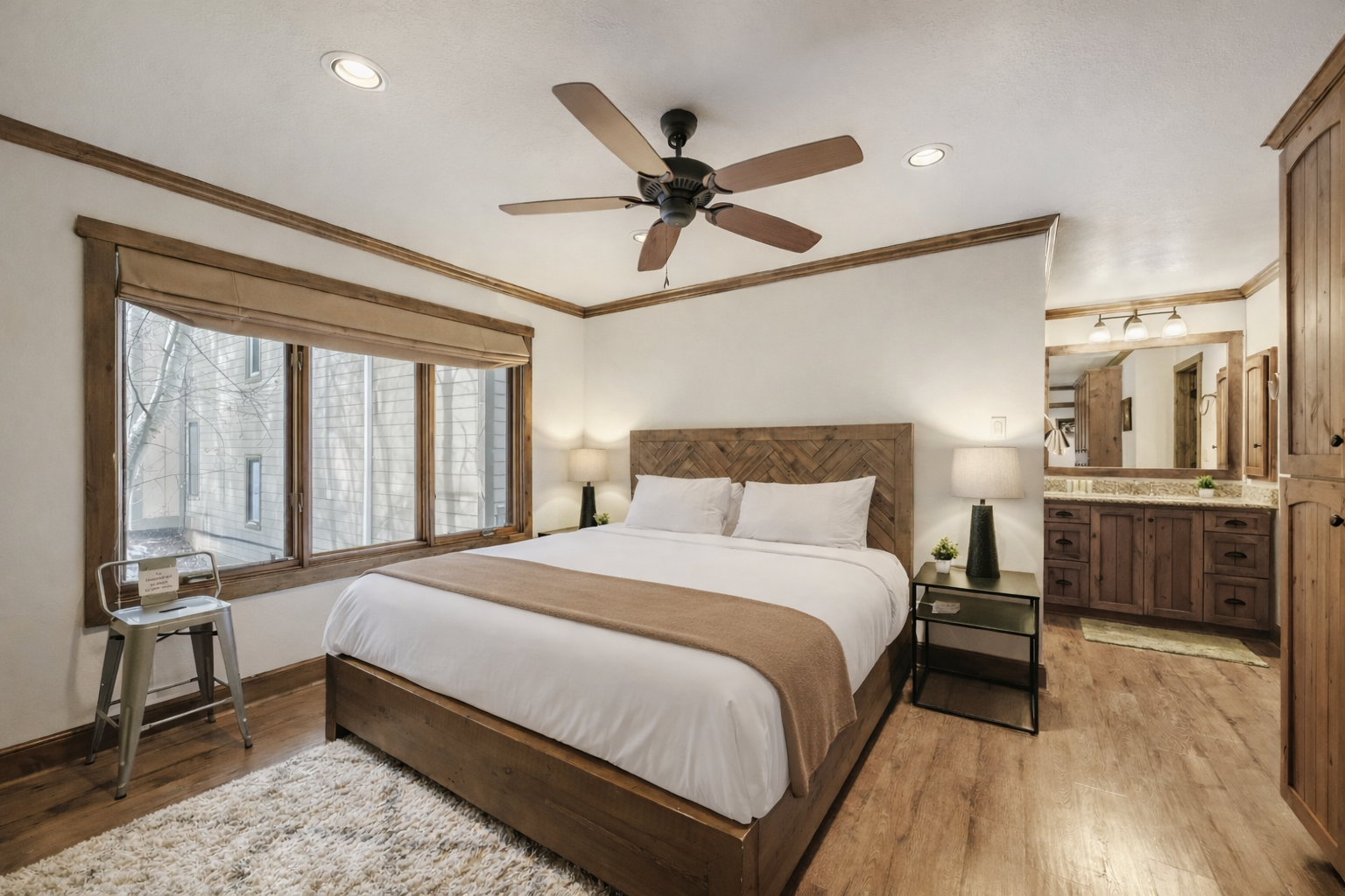 Unwind in your serene bedroom sanctuary featuring plush linens, warm wood tones, and an ensuite bathroom.