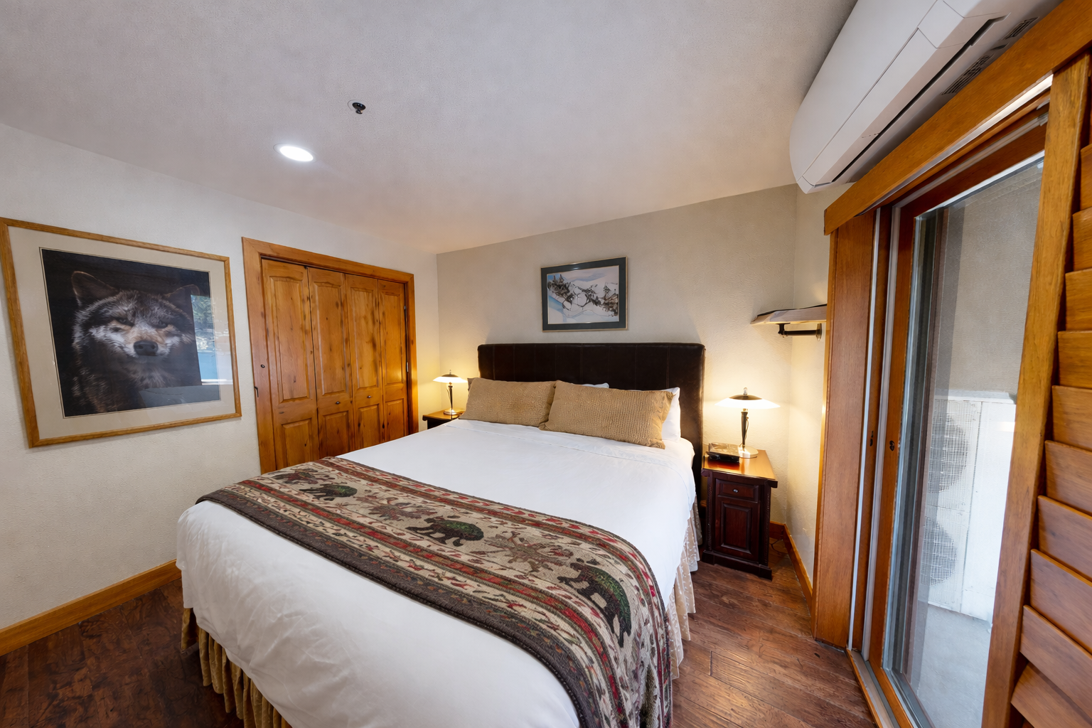 Drift off in your cozy mountain bedroom with warm wood tones, soft bedside lighting, and rustic charm for the perfect alpine retreat.