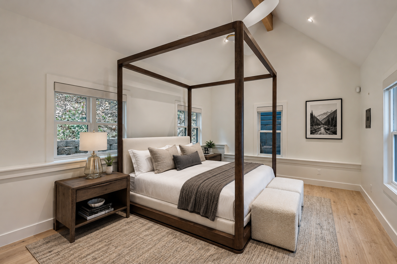 Drift off to sleep beneath the elegant canopy frame, surrounded by soft linens and natural light streaming through multiple windows. Your private retreat awaits.