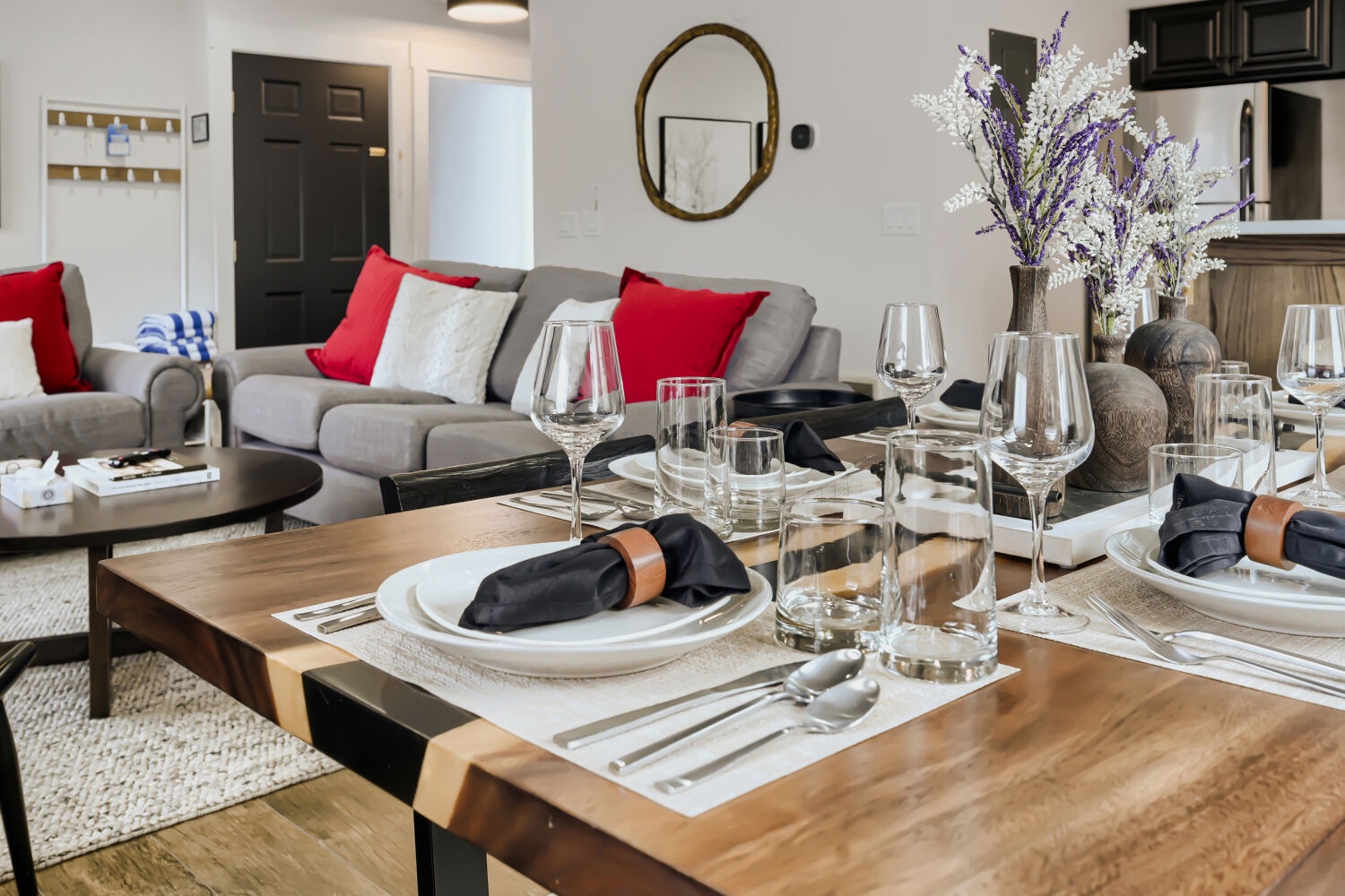 Gather around this elegantly set dining table where memorable meals await, while you unwind on the plush sofa in your stylish retreat.