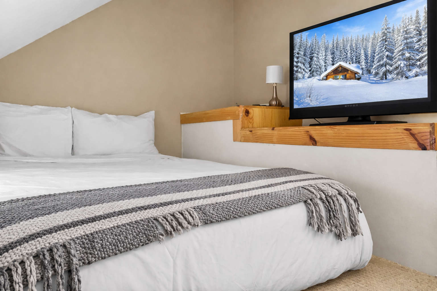 Unwind in your cozy bedroom with crisp linens and a large TV, perfect for relaxing after your adventures.
