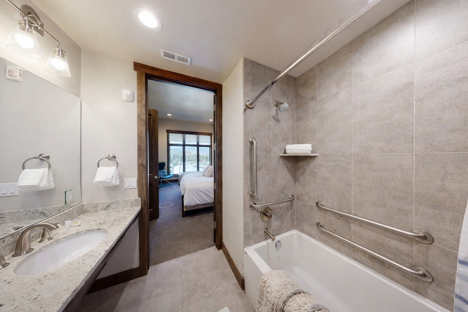 Unwind in your spa-inspired ensuite with marble surfaces and a deep soaking tub, where safety meets luxury with thoughtful grab bars.