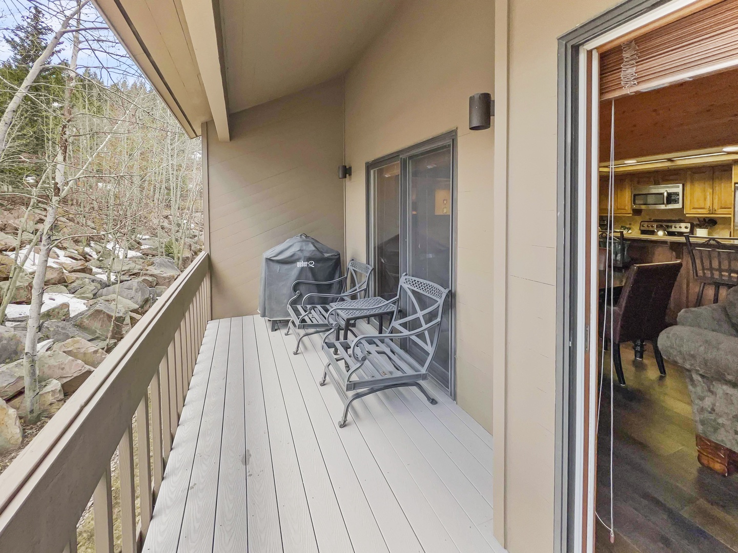 Step onto your private balcony and breathe in the mountain air. With cozy seating and a grill ready for your use, it's the perfect spot to unwind after a day of exploring.