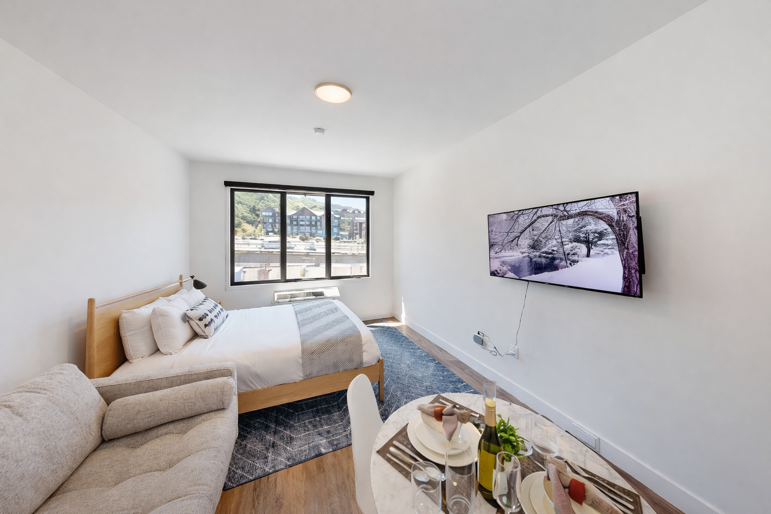 Retreat to this modern studio featuring a comfortable queen bed, a charming dining nook, and a cozy seating area.