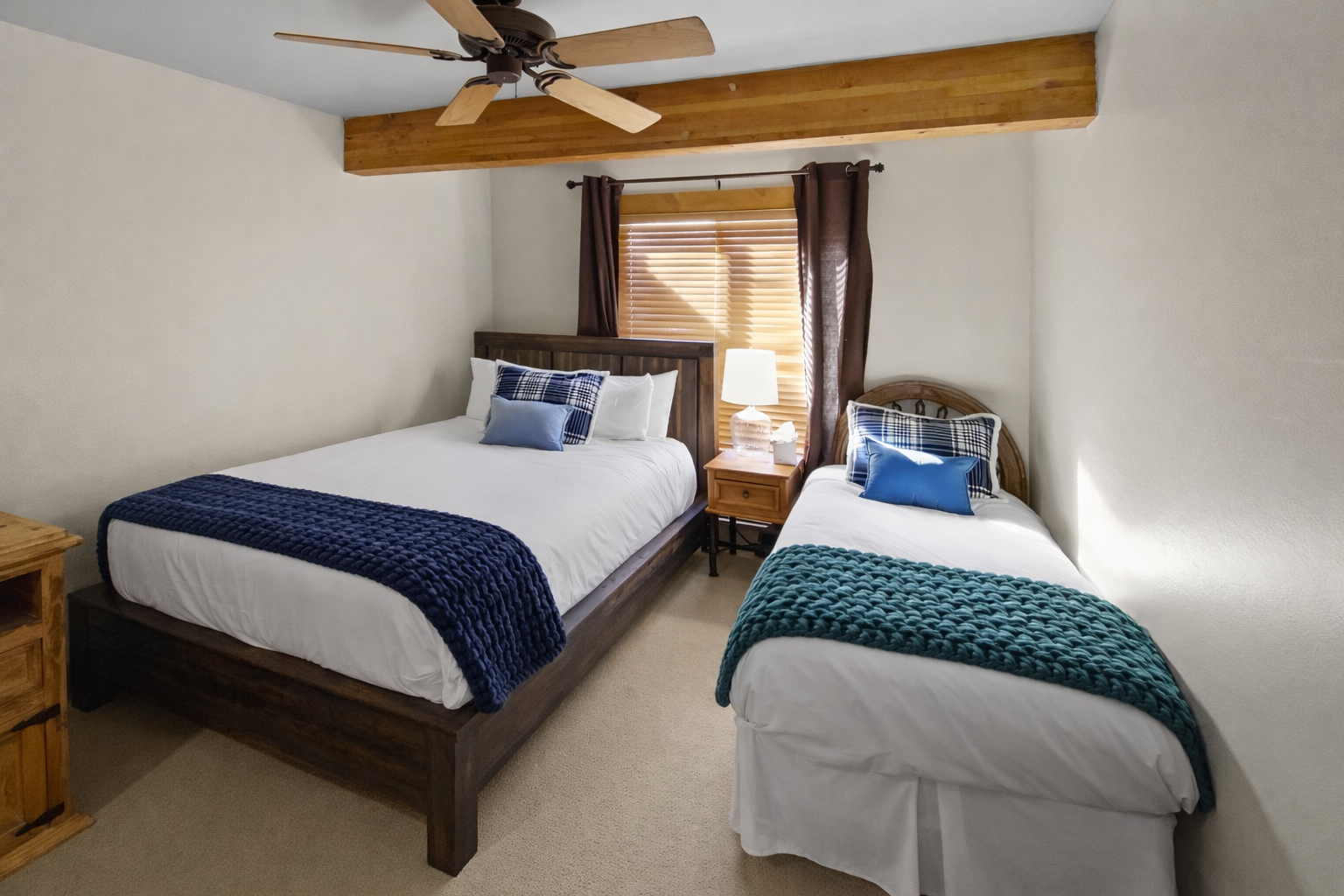 Relax in your cozy twin bedroom with rustic wood beams, crisp linens, and gentle natural light filtering through.