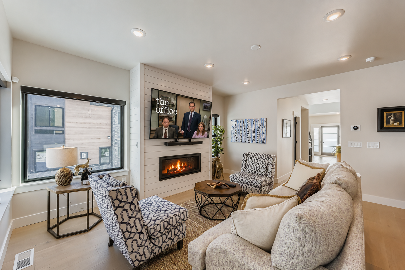 Unwind in your elegant living room where a crackling fireplace meets modern comfort, perfect for cozy evenings and entertainment.