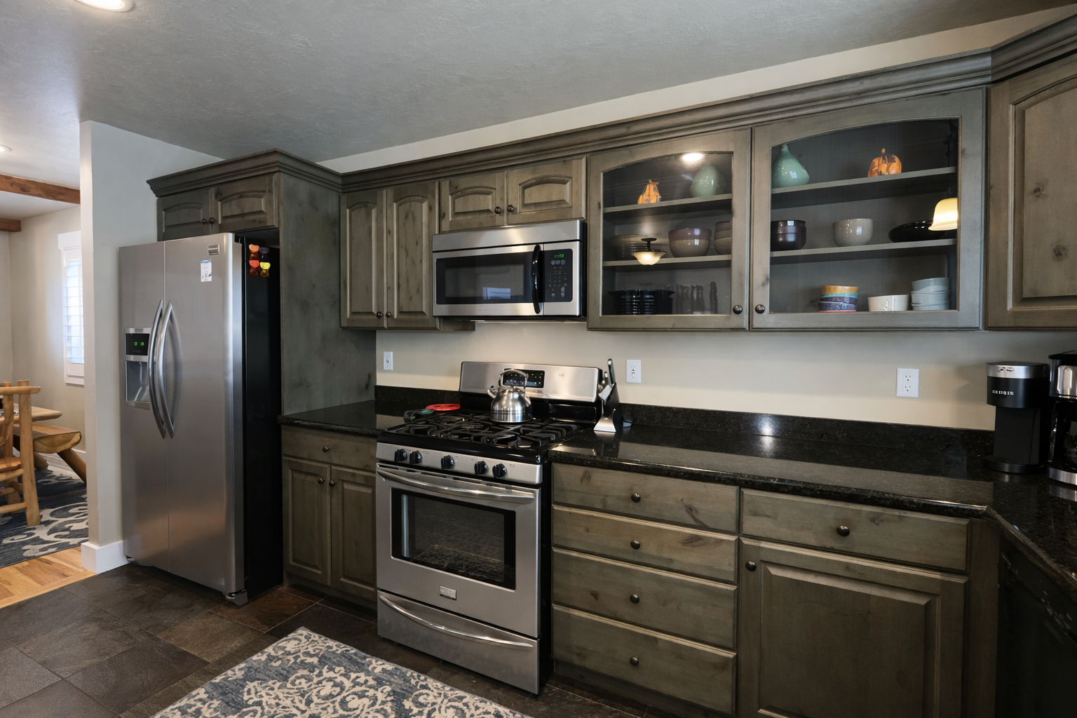 Cook your favorite meals in this fully-equipped kitchen featuring stainless steel appliances, granite countertops, and ample cabinet space for all your culinary adventures.