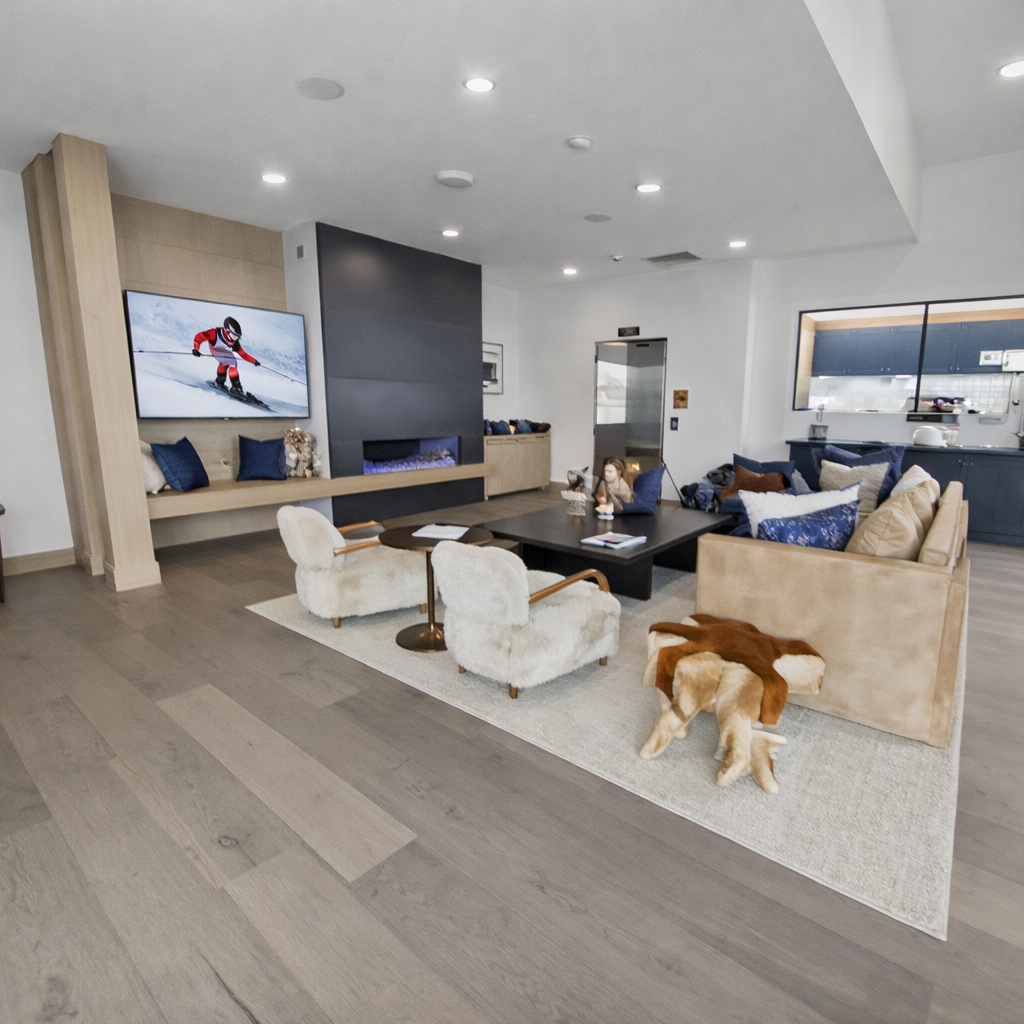 Unwind in the inviting community clubhouse, featuring a cozy fireplace, comfortable lounge seating, a fun game room with shuffleboard and ping pong, and a convenient wet bar.
