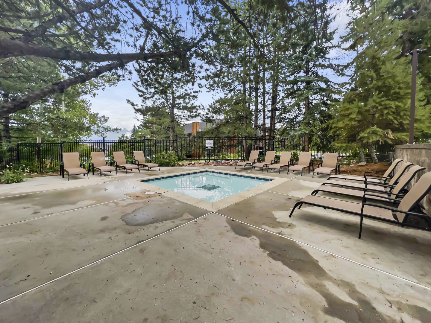 Community Outdoor Hot Tub -Soak away your cares in the hot tub under a canopy of towering pines, with plenty of lounge chairs nearby for your comfort and relaxation.
