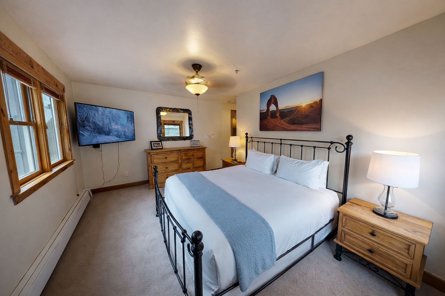 Cozy mountain retreat with a plush king bed and TV. Step onto the private deck with forest views.