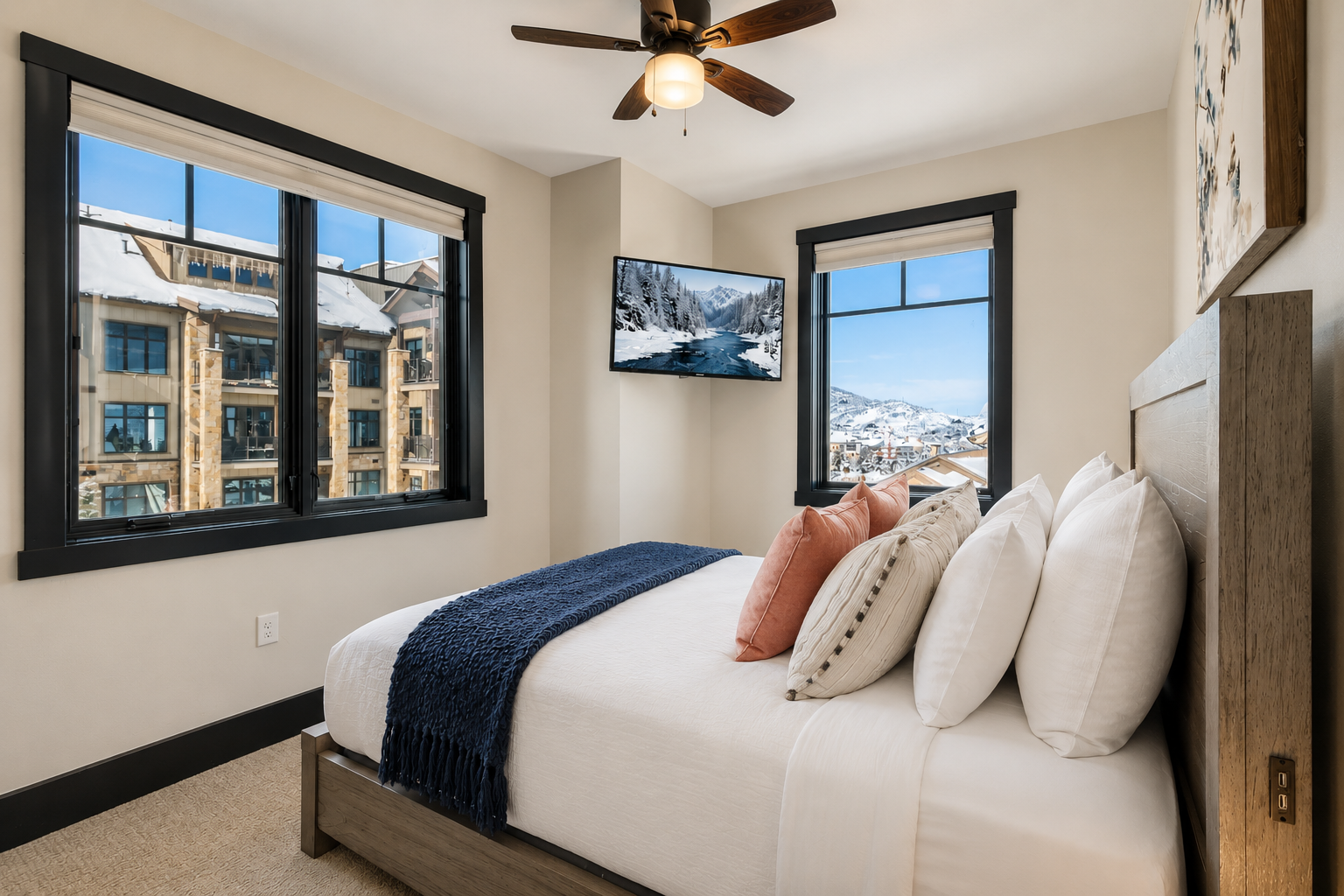 Experience modern rustic elegance in this well-lit suite. Features include a comfortable queen bed, soft textiles, and scenic views, providing a peaceful and inviting stay for every guest.