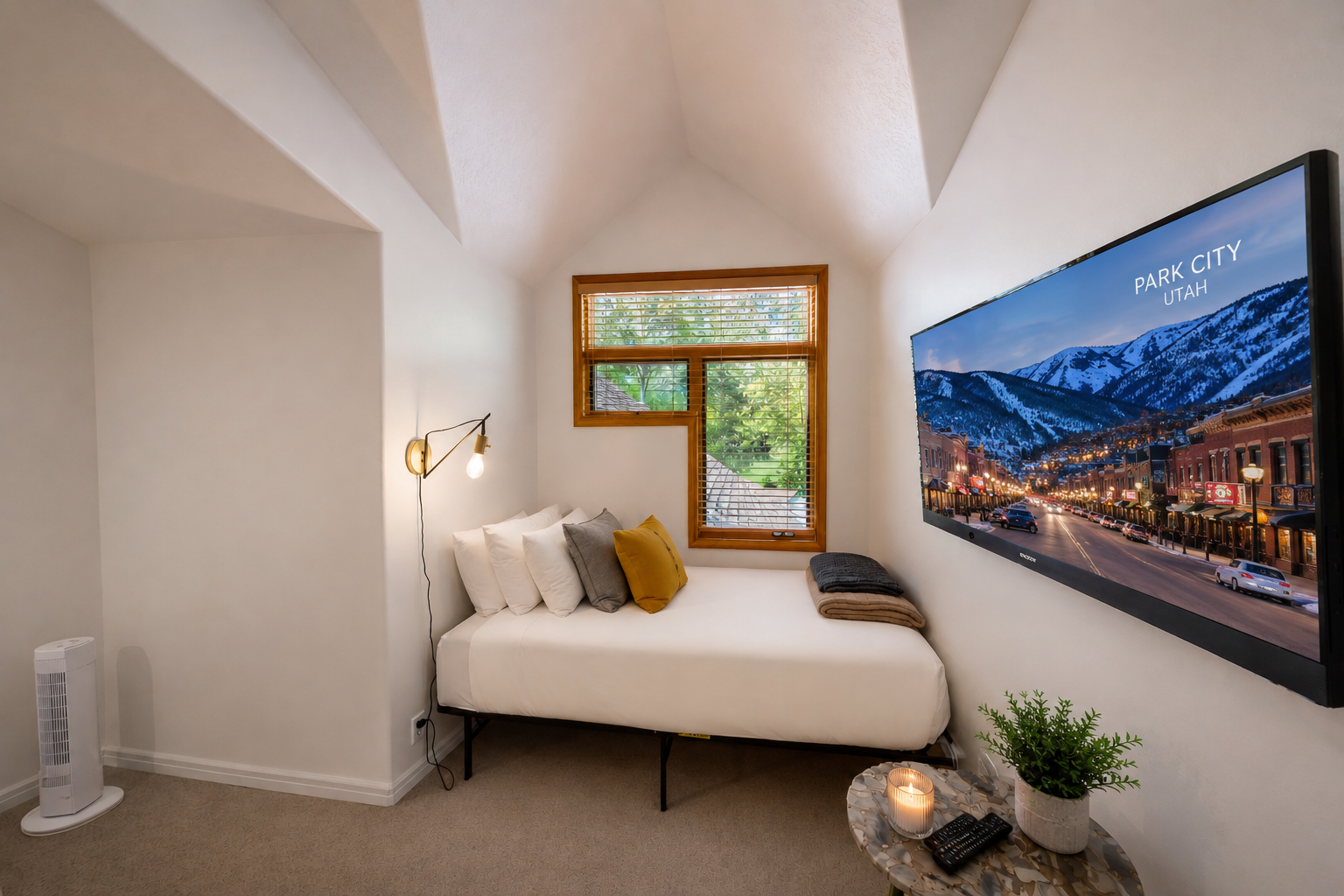 Cozy bedroom with vaulted ceilings, plush bedding, and mountain-view entertainment awaits your restful retreat.