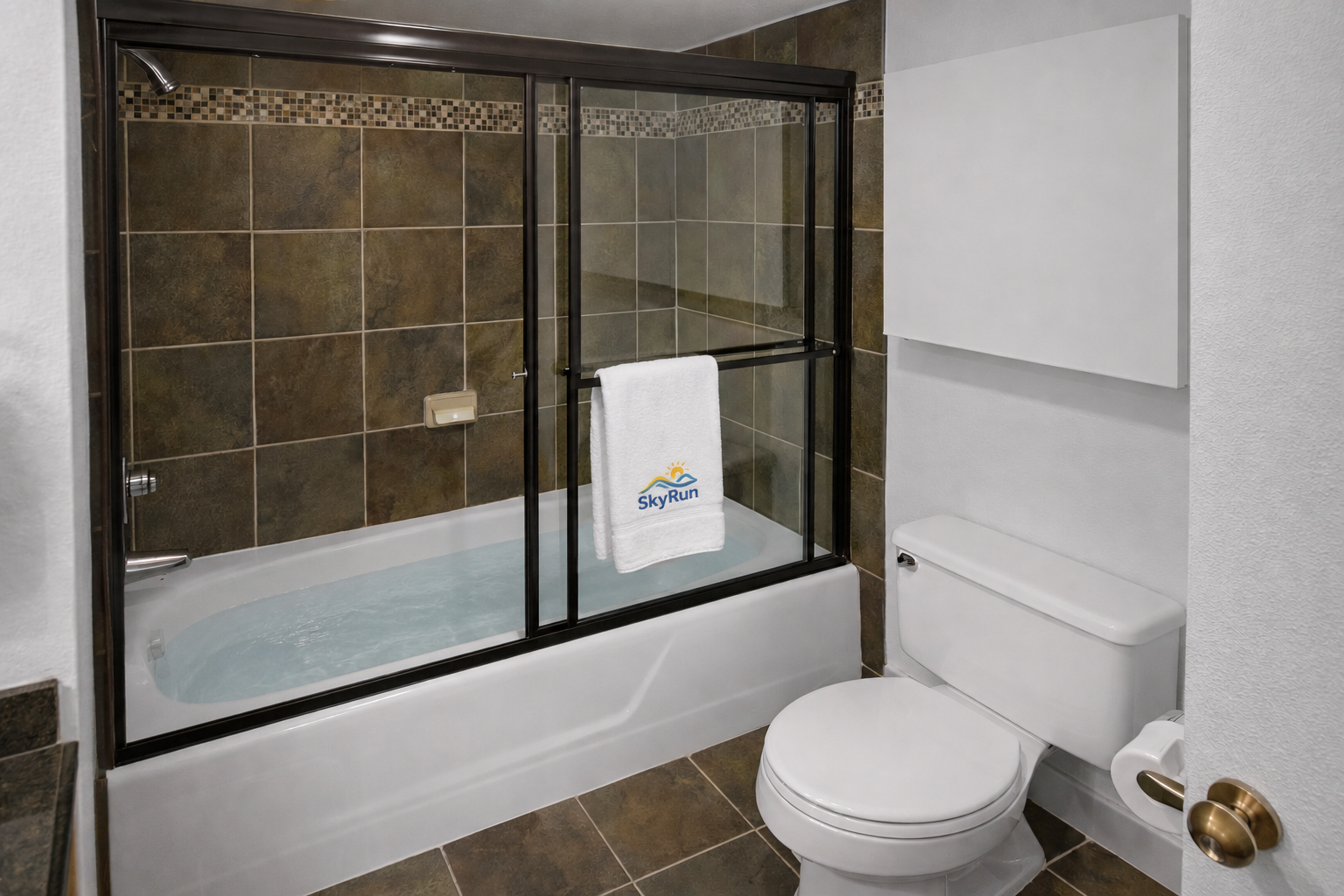 Relax in your private bathroom with a deep soaking tub, sleek glass enclosure, and spa-like tile details designed to help you unwind after exploring the area.