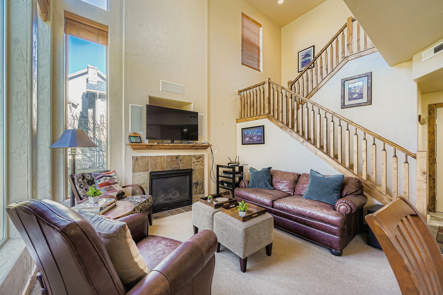 Unwind in this spacious living room with rich leather seating, a cozy fireplace, and entertainment center - your perfect home base for relaxation.