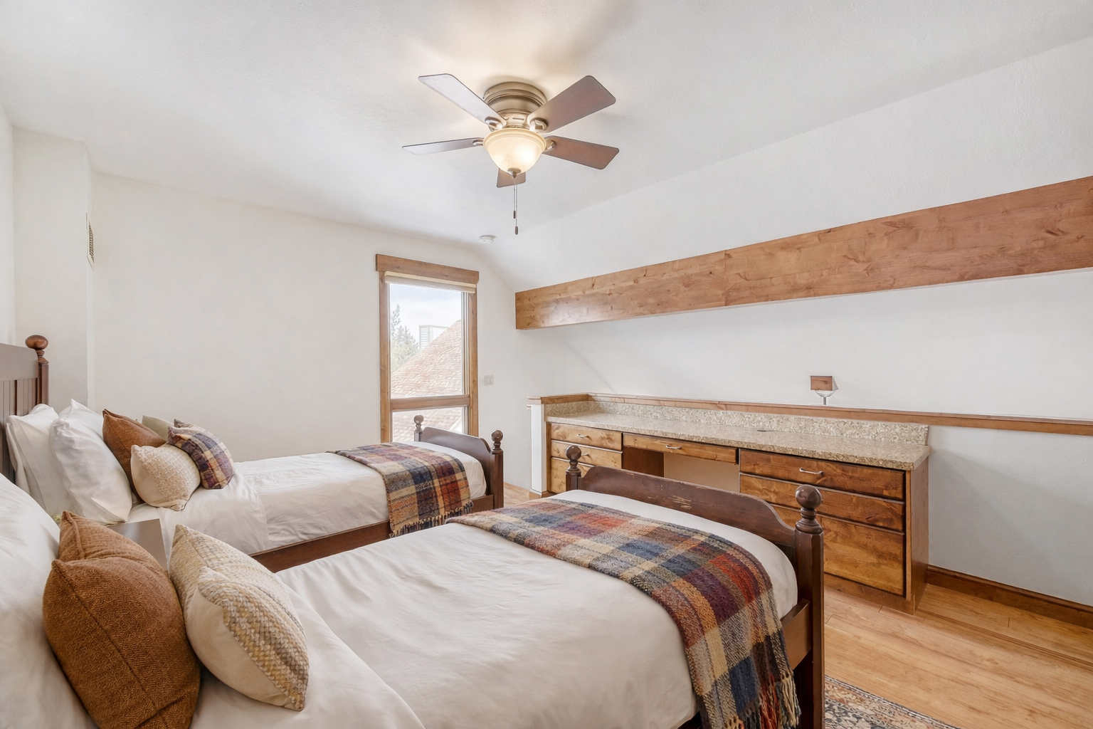 Drift off in your cozy twin bedroom, where rustic wood beams and plaid throws create mountain cabin charm.