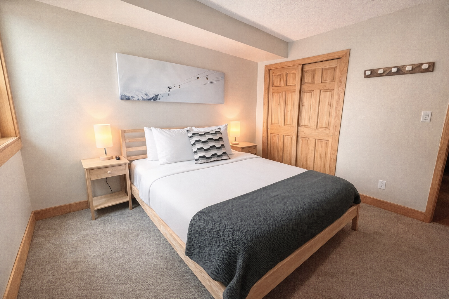 Cozy guest bedroom with a comfortable bed, ceiling fan, and desk. Perfect for a restful stay in Park City.