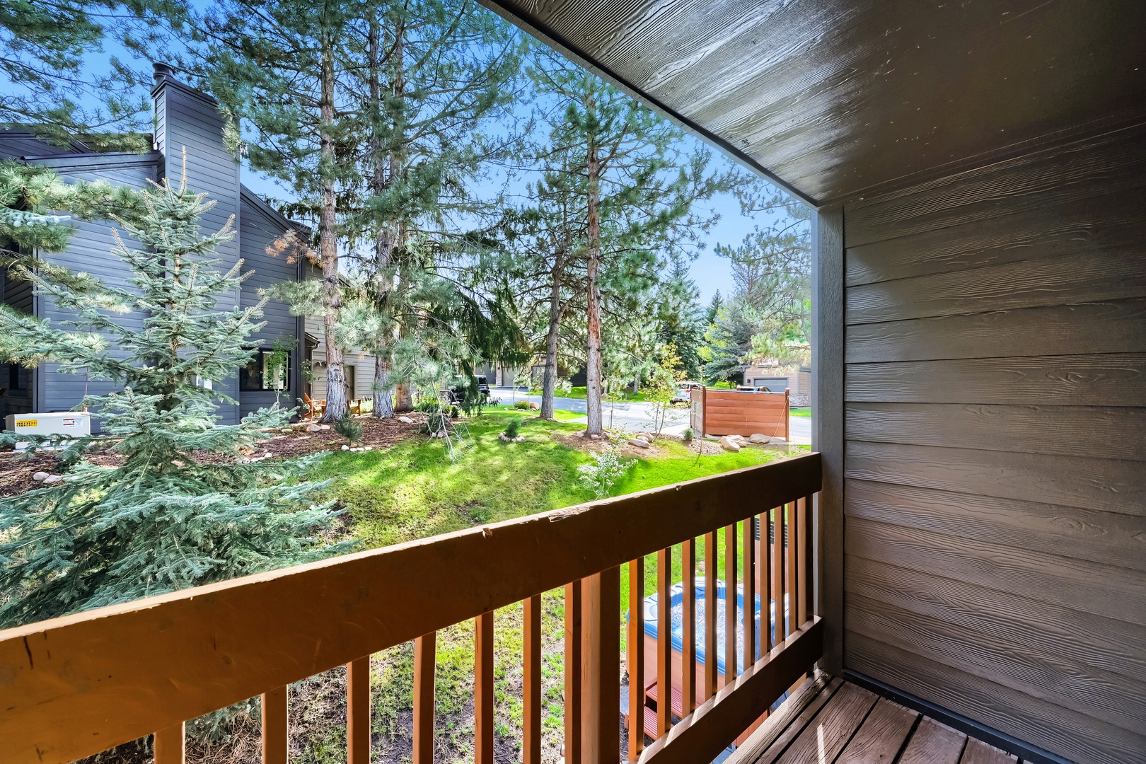 Step onto your private balcony and breathe in the fresh mountain air, surrounded by towering pines and peaceful green spaces that make every morning feel like a retreat.