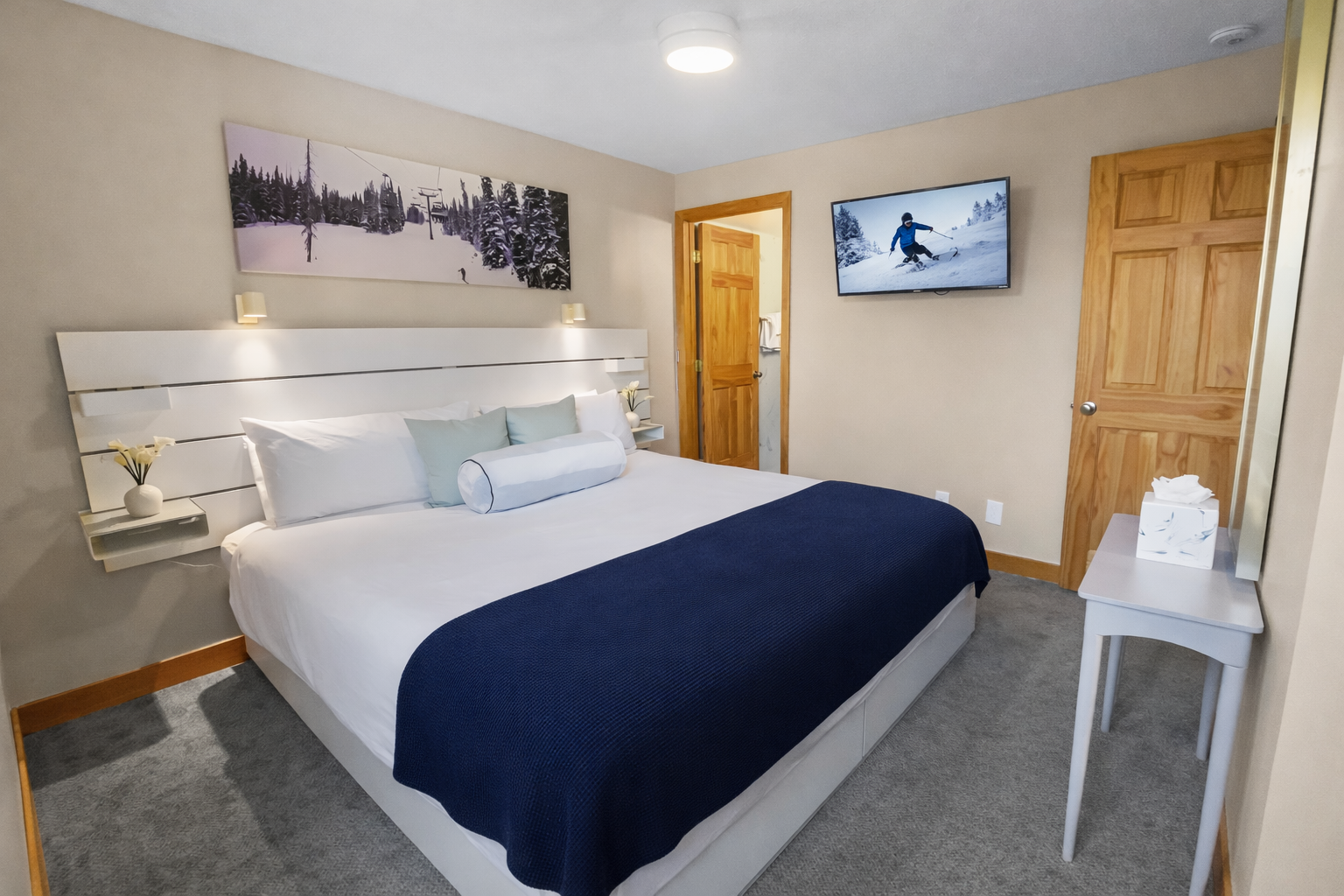 Peaceful primary bedroom with a comfortable king-size bed, ceiling fan, and lovely artwork. A tranquil retreat for a restful stay in the mountains.