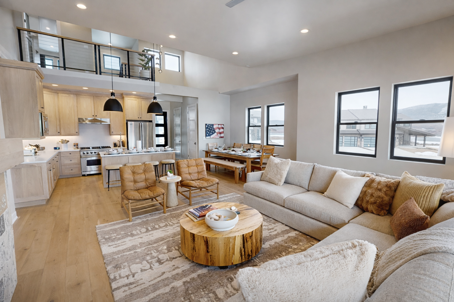 Relax in your spacious open-concept haven where natural light floods through expansive windows, highlighting the warm wood accents and plush sectional sofa perfect for gathering.
