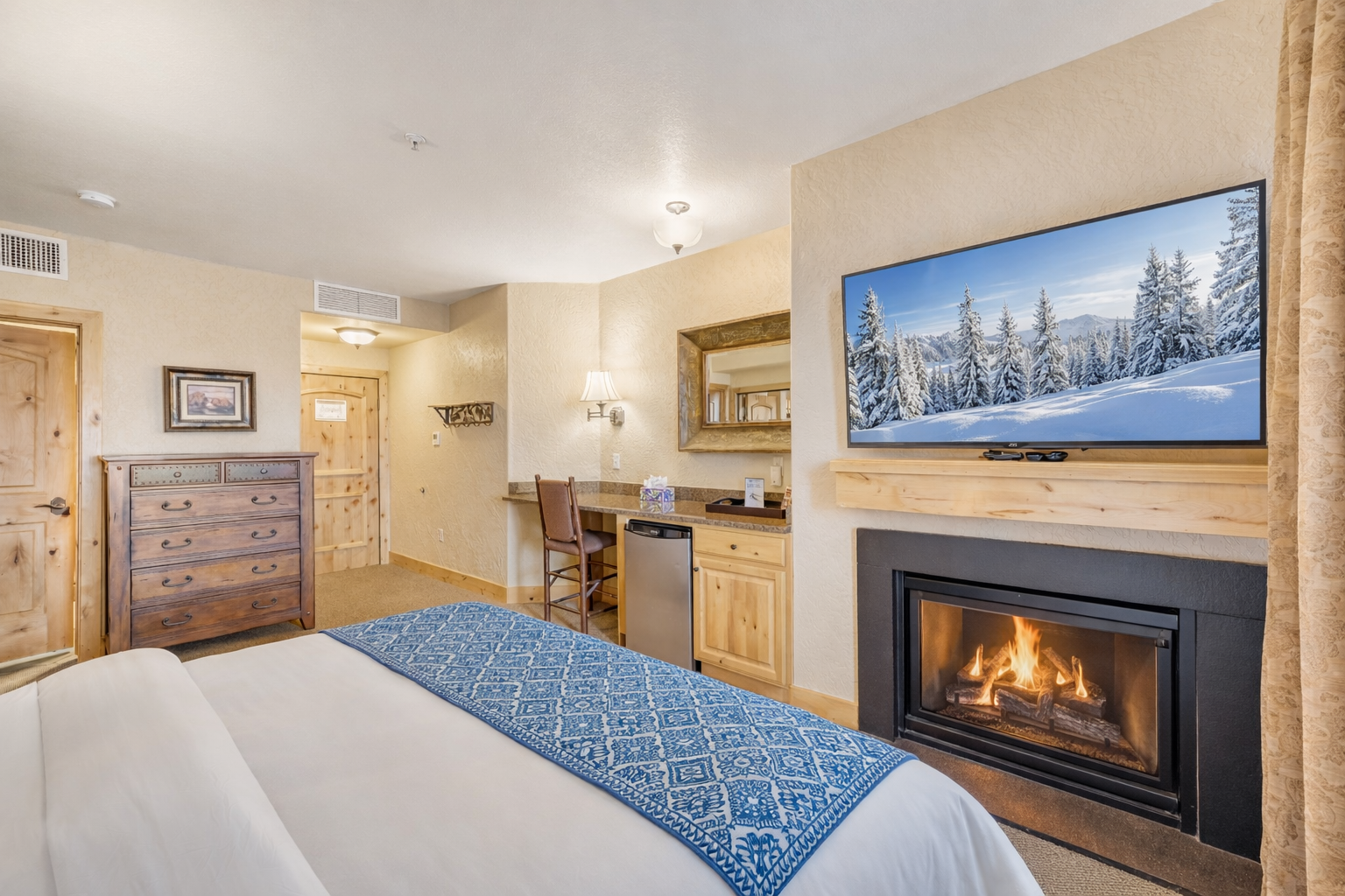 Relax in this spacious master suite featuring a king bed and handcrafted wood furniture. A serene retreat designed for ultimate comfort and a restful night's sleep.
