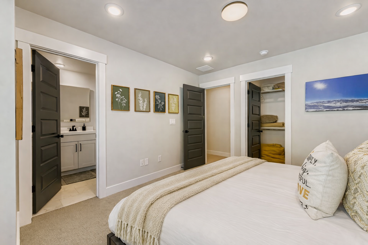 Sink into soft linens and unwind in your thoughtfully designed bedroom, where peaceful artwork and warm lighting create the perfect retreat after exploring.