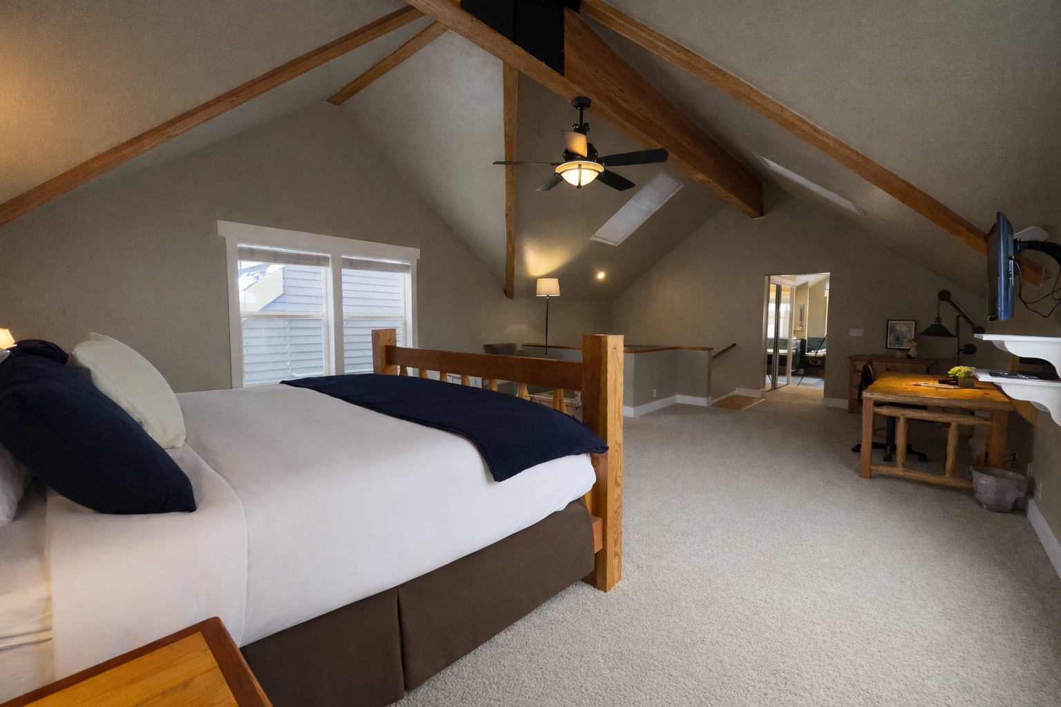 Relax in this spacious master suite on its own private floor. Features include a king-sized log bed, vaulted ceilings, and a large walk-in closet for the ultimate mountain retreat.