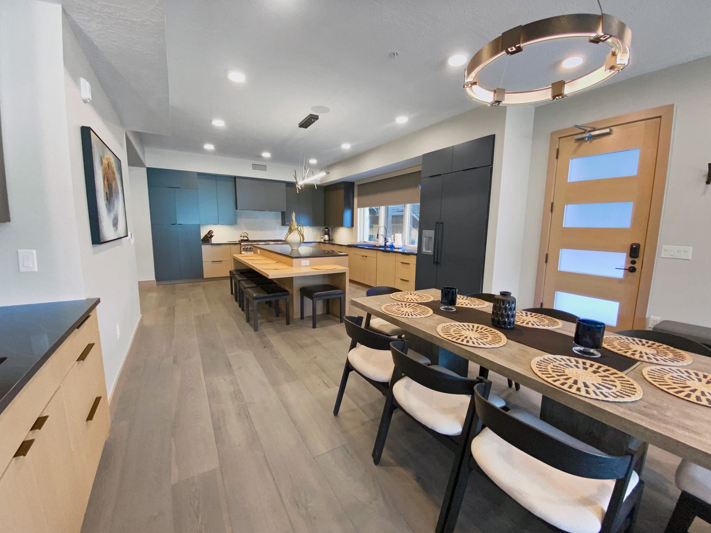 Gather around your elegant dining table set for six, then step into your modern kitchen with spacious island seating. Warm wood tones and sleek design invite effortless cooking and memorable meals together.