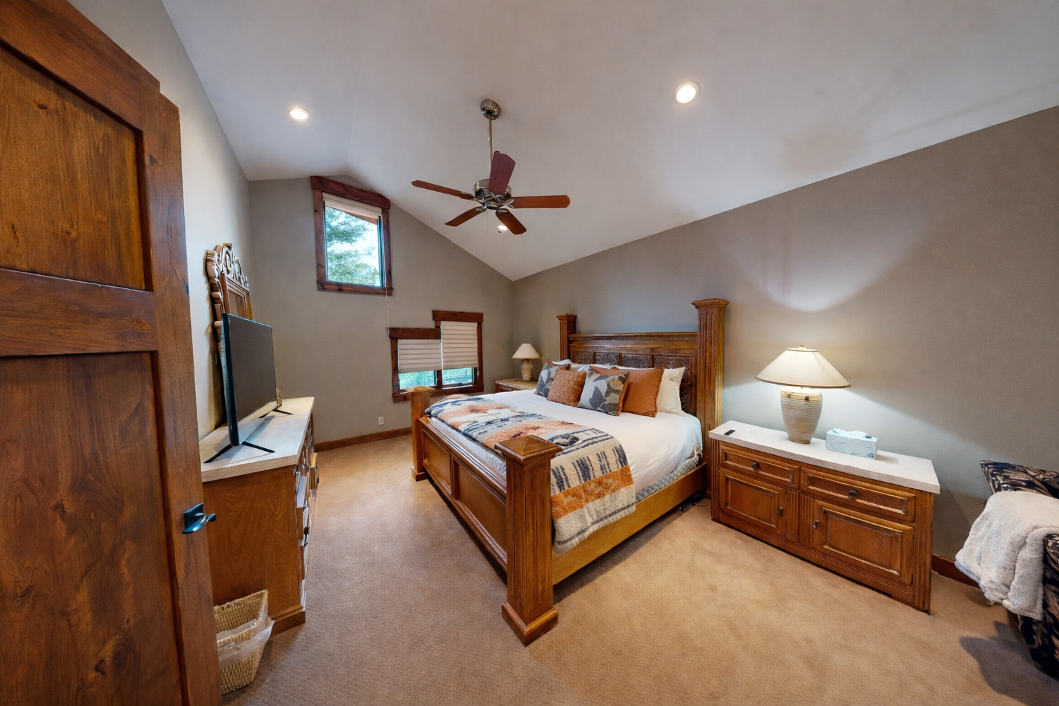 Unwind in your peaceful bedroom sanctuary with rich wood furnishings, cathedral ceilings, and soft lighting creating pure tranquility.