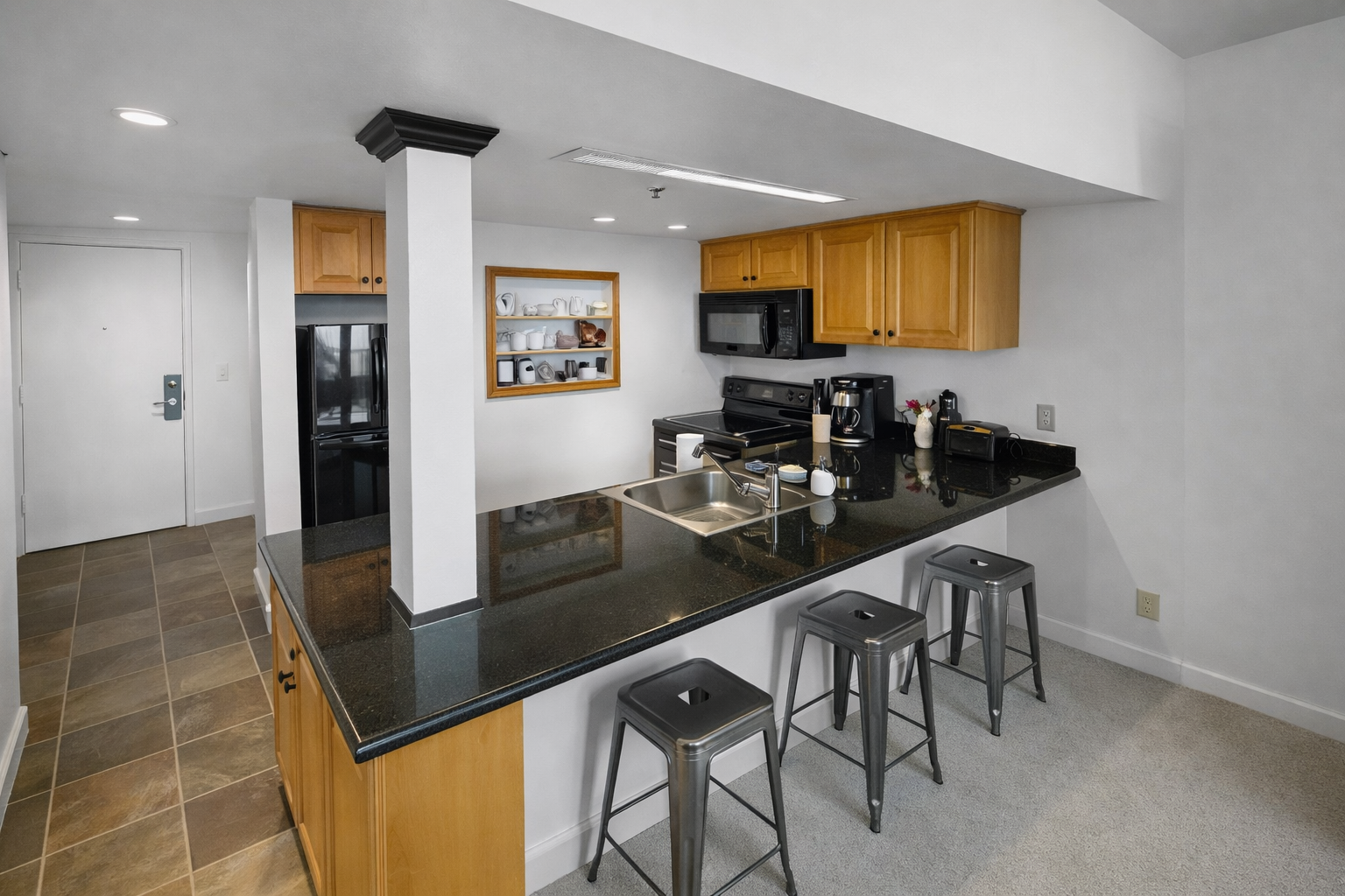 Your fully equipped kitchen features granite counters, modern appliances, and a breakfast bar—perfect for whipping up morning coffee or gathering with friends over a home-cooked meal.