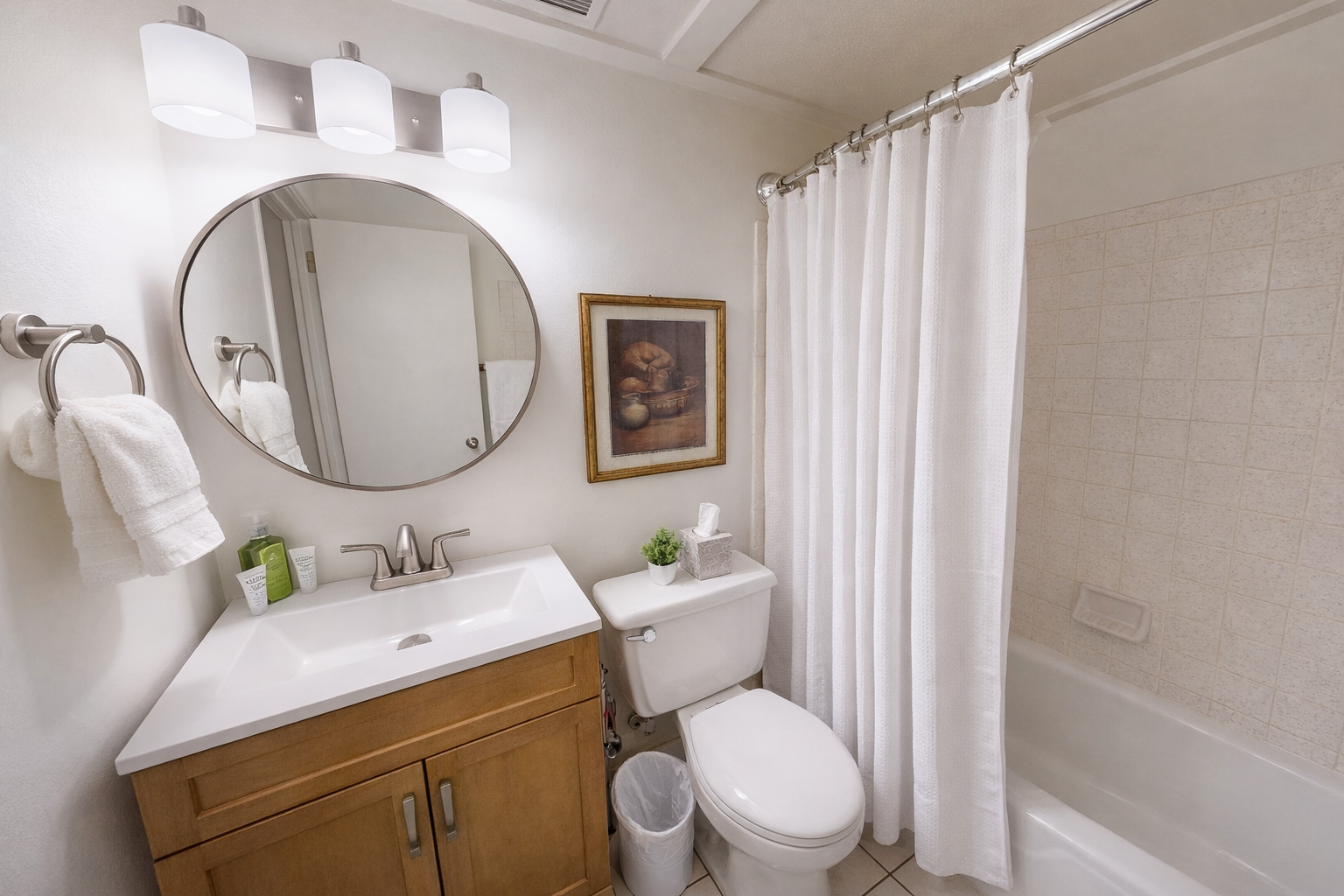 Modern & clean full bathroom featuring a sleek tub/shower combo and a stylish vanity. A refreshing space to unwind during your stay.