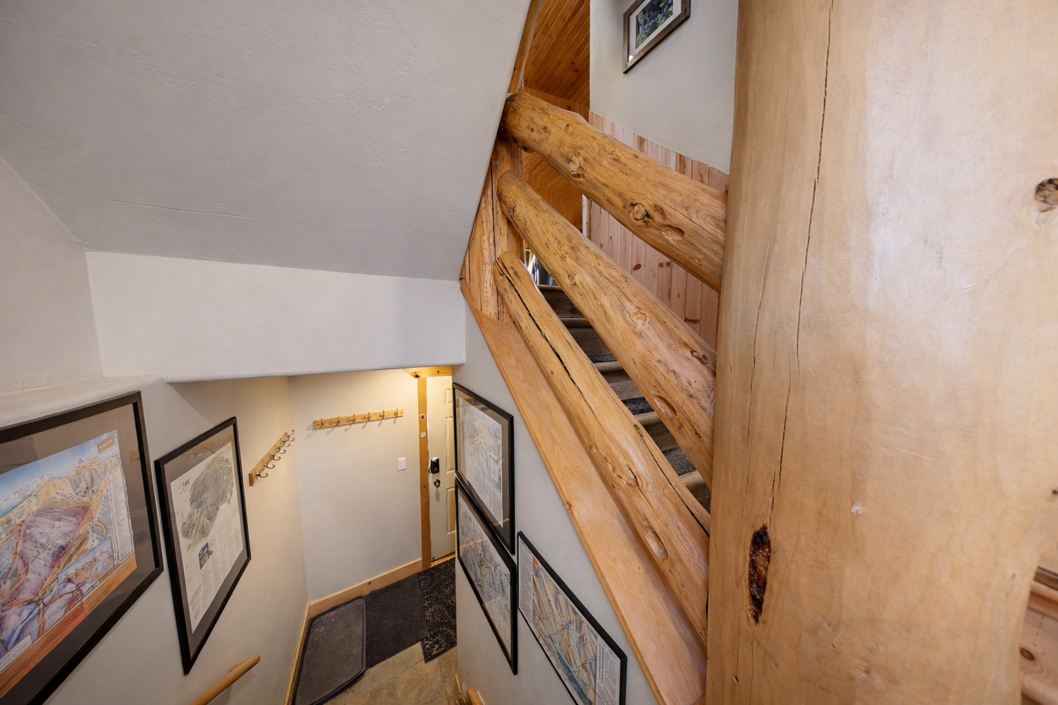 Ascend these handcrafted wooden stairs surrounded by charming artwork that adds character to your mountain retreat.