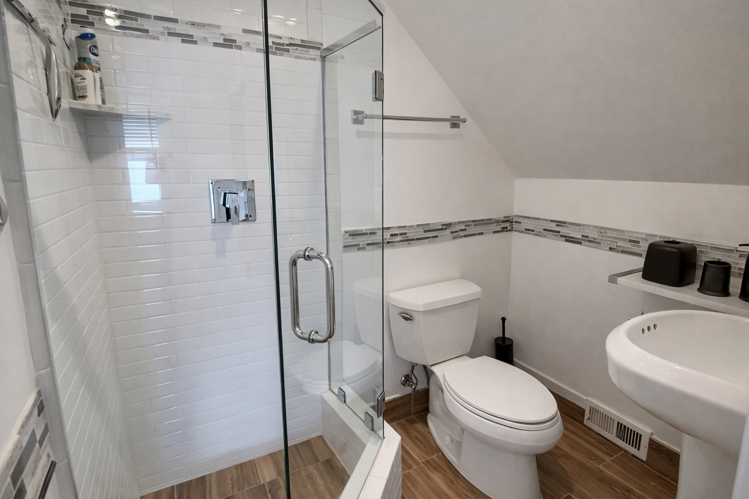 Your private bathroom features a spacious glass shower, modern fixtures, and thoughtful design touches for your comfort.