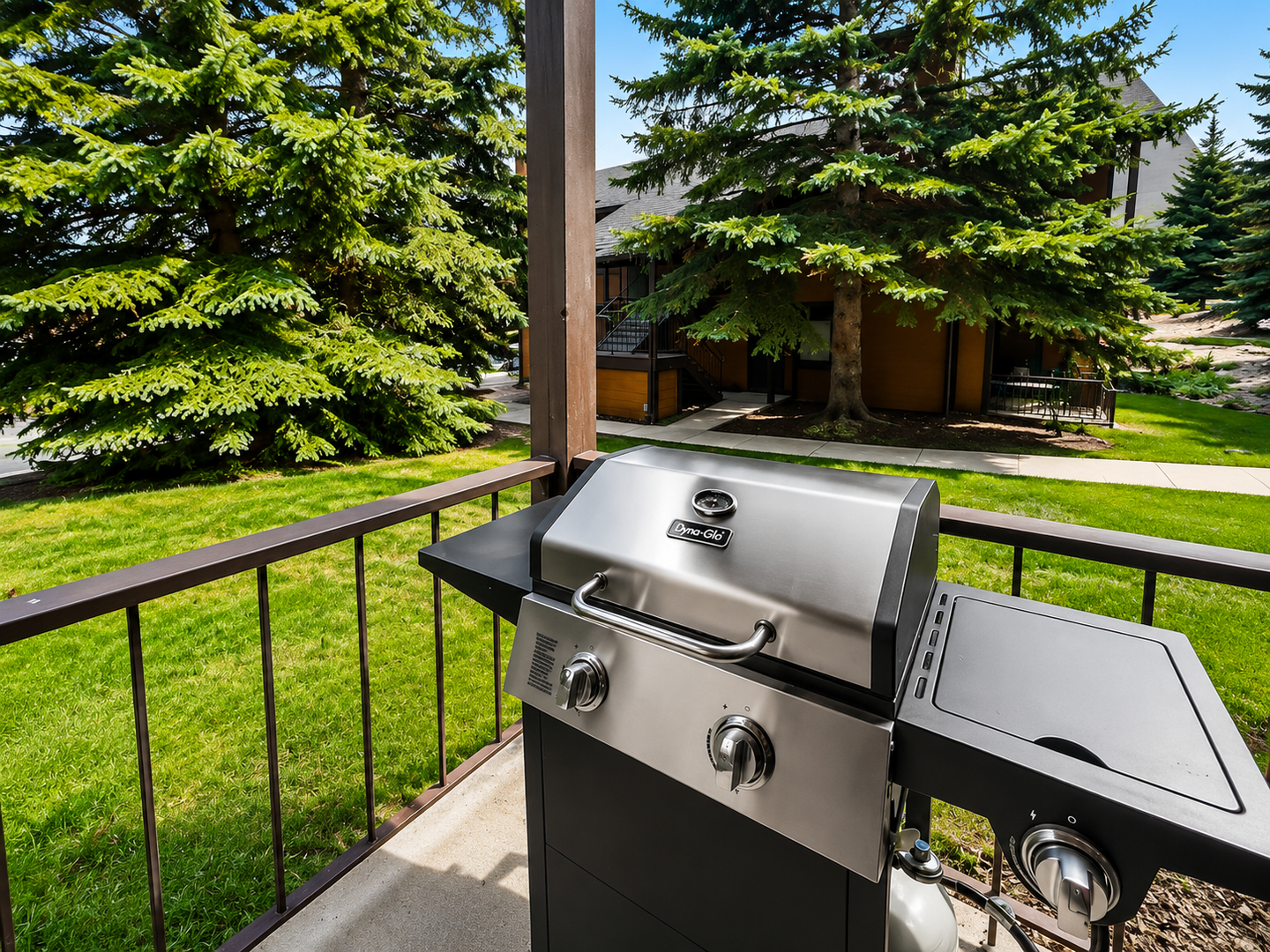 Fire up the grill on your private balcony and savor mountain views framed by towering evergreens. Fresh air, green lawns, and your outdoor oasis await.