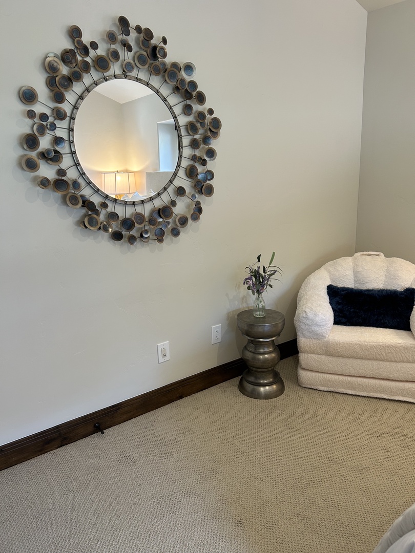 Get ready in style with a beautiful bedroom mirror and a cozy seat, creating the perfect spot to sit, relax, and prepare for the day.