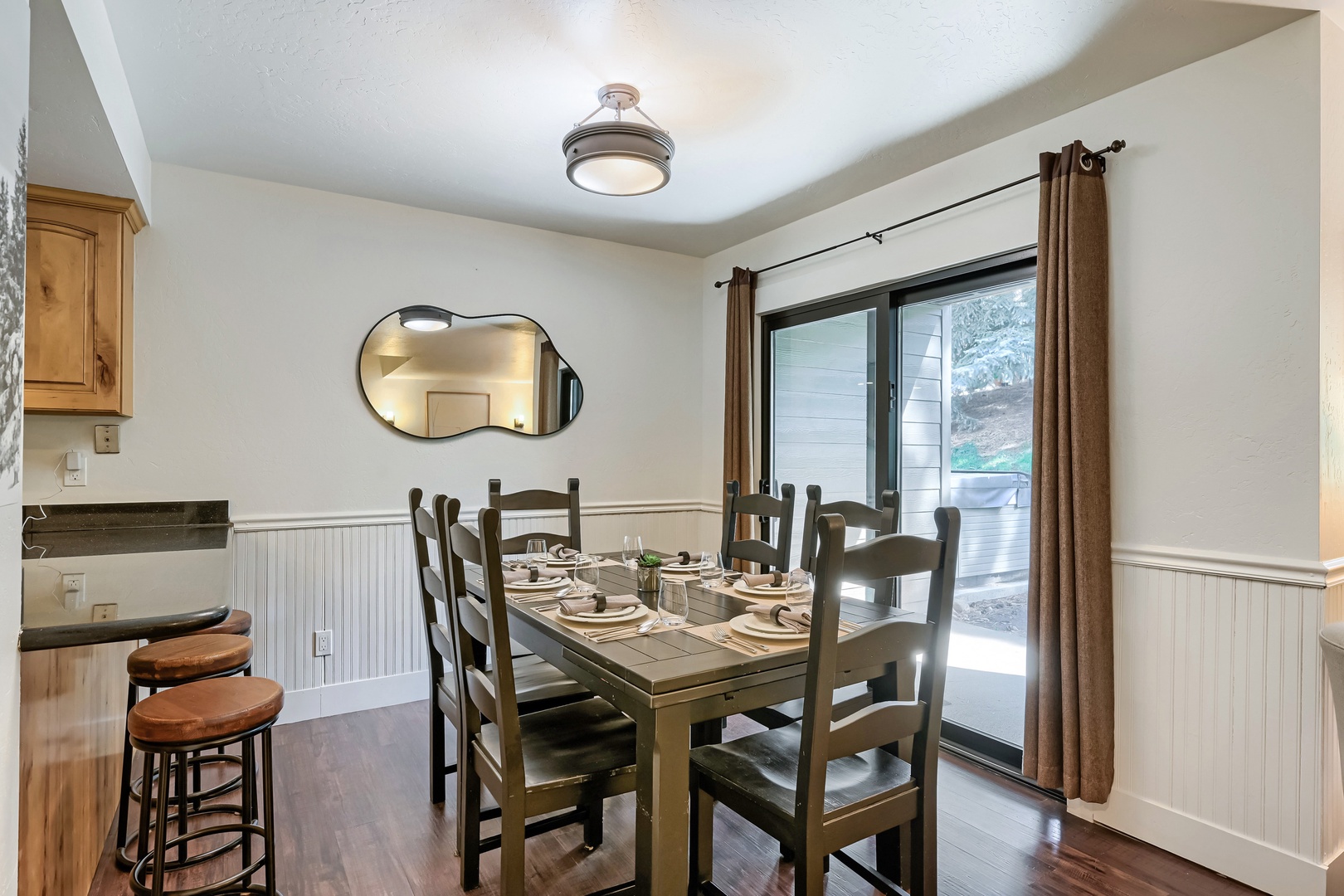 A welcoming dining space where you can gather for home-cooked meals with natural light streaming through sliding doors to your private patio.