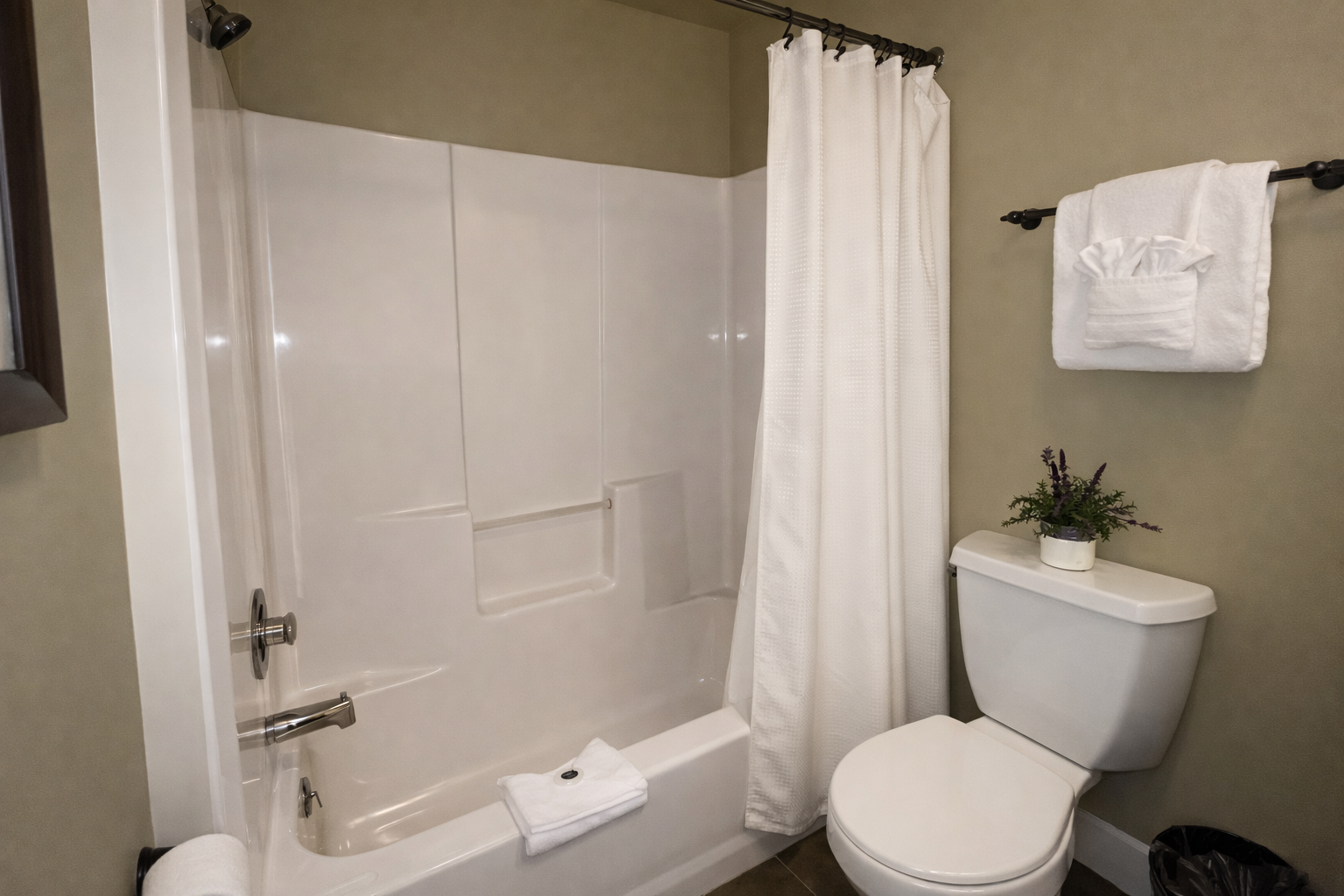Fresh white linens and a spotless tub-shower combo make your morning routine feel like a spa retreat.