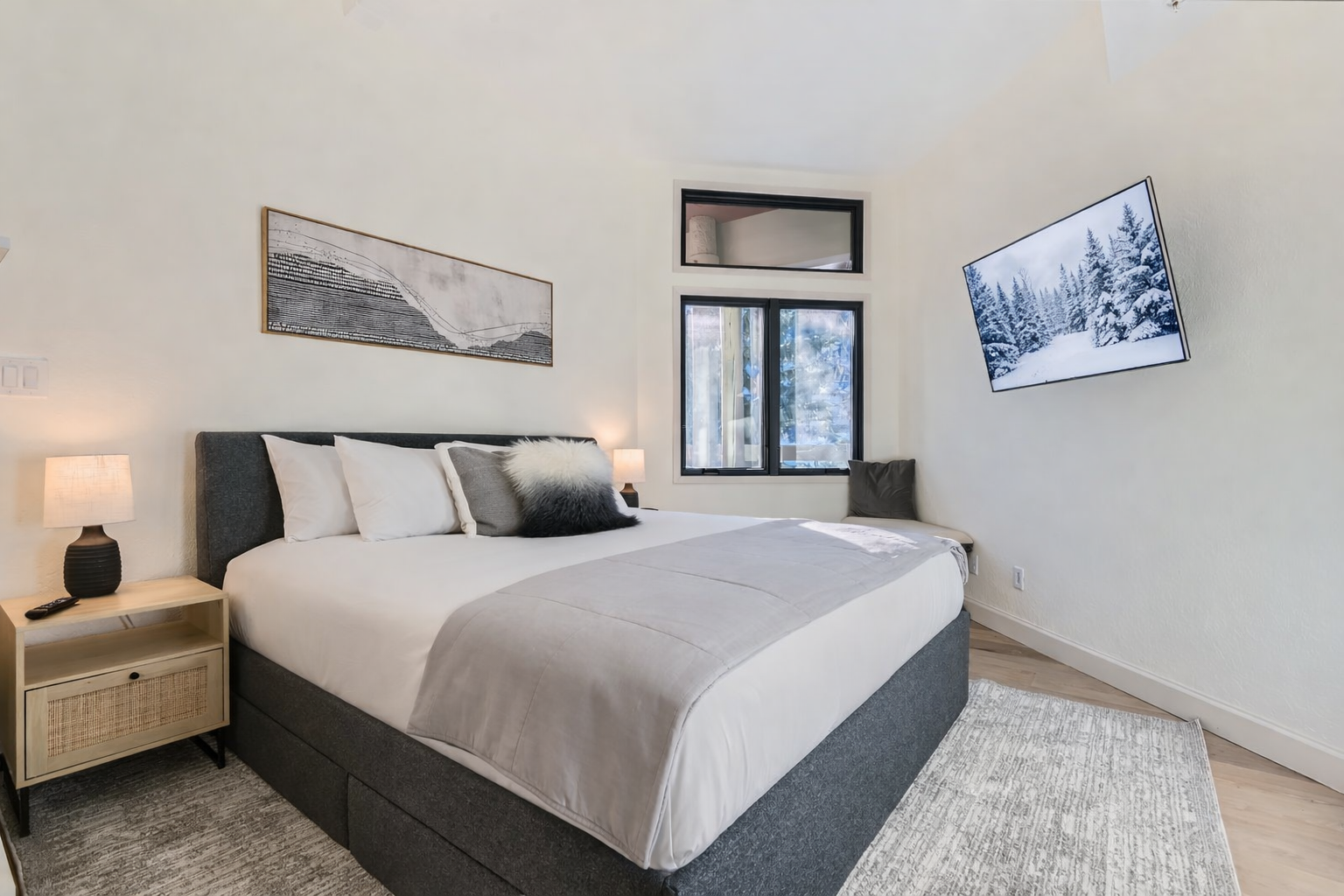 Unwind in your serene bedroom sanctuary, where soft lighting and mountain artwork create the perfect atmosphere for restful nights.