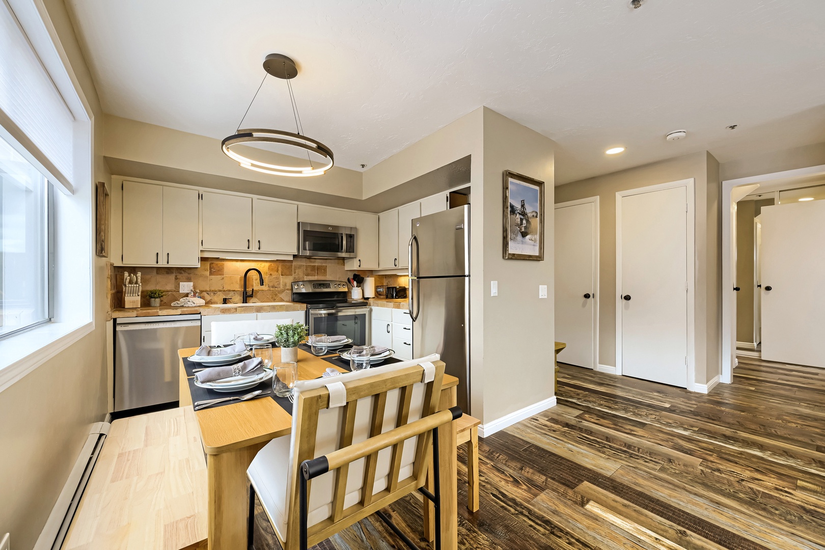 Your fully equipped kitchen and dining space welcomes you home with warm lighting, modern appliances, and all the comforts you need to cook and share meals together.