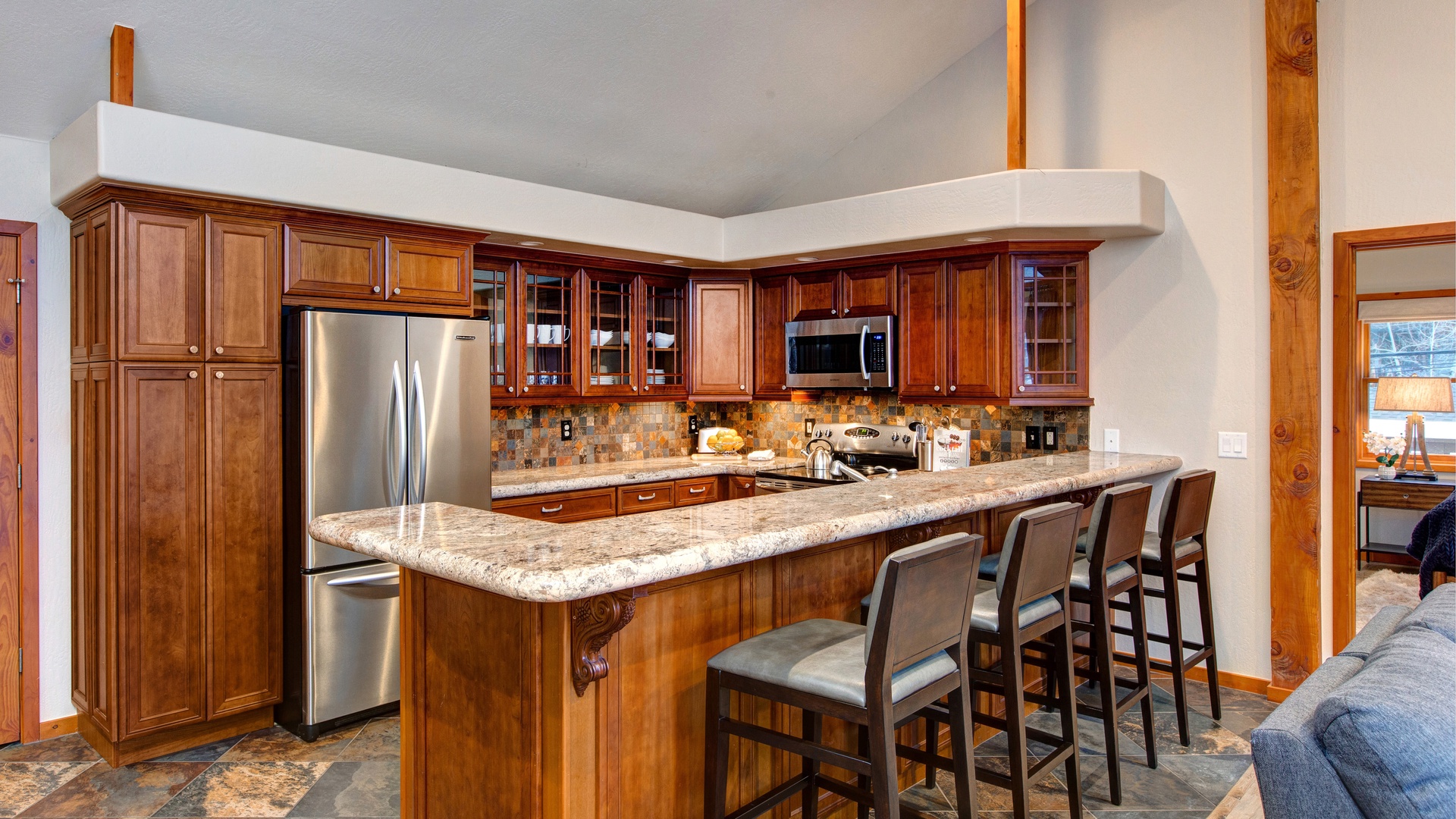 Your gourmet kitchen features rich wood cabinetry, granite counters, and stainless appliances perfect for memorable meals together.